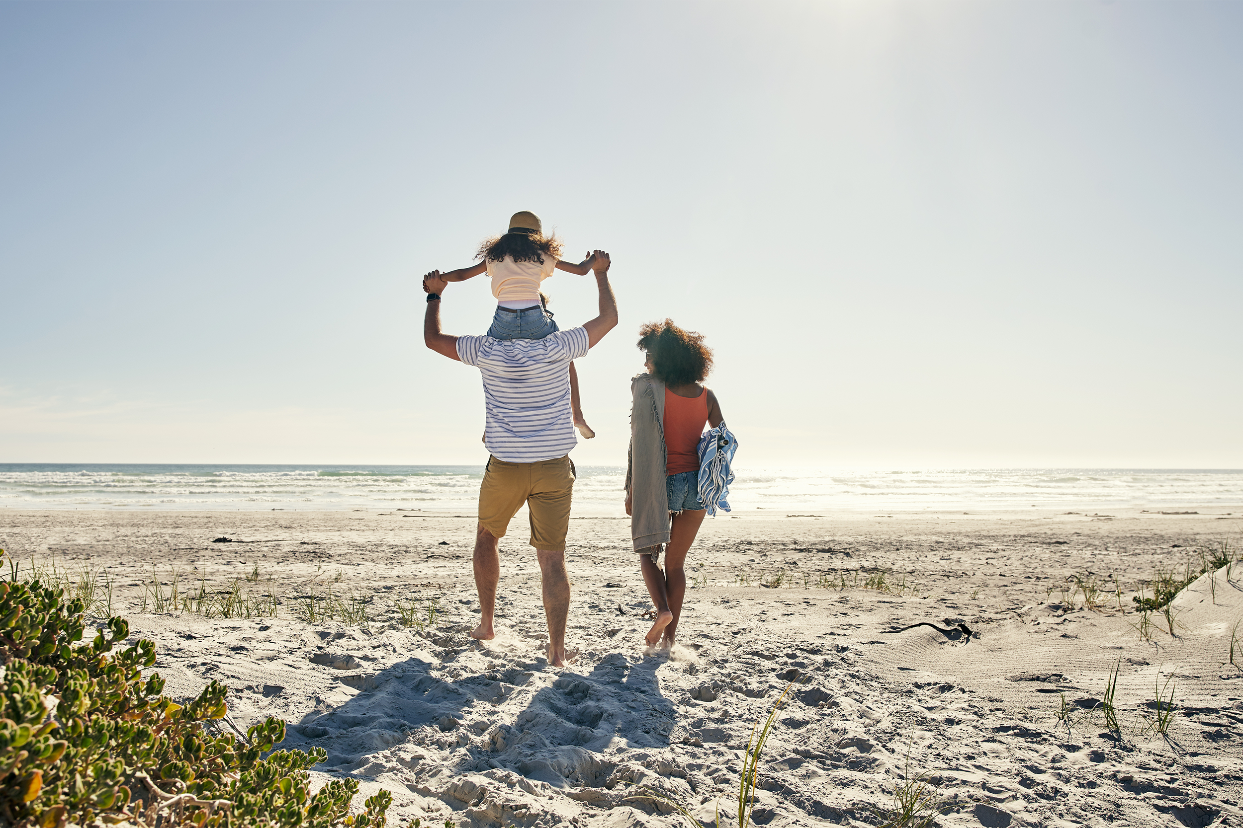 family walking to beach