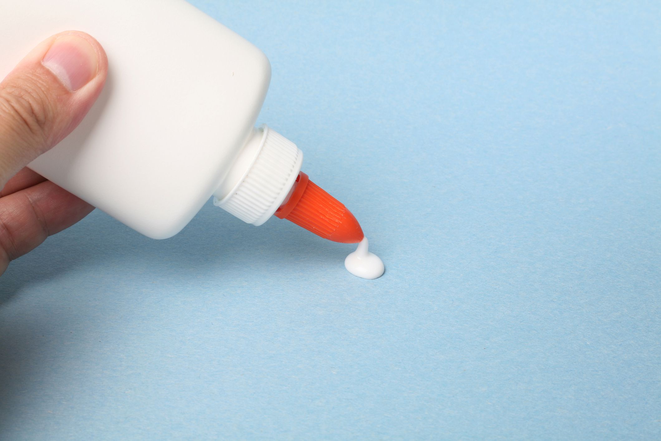 a bottle of glue, school supplies