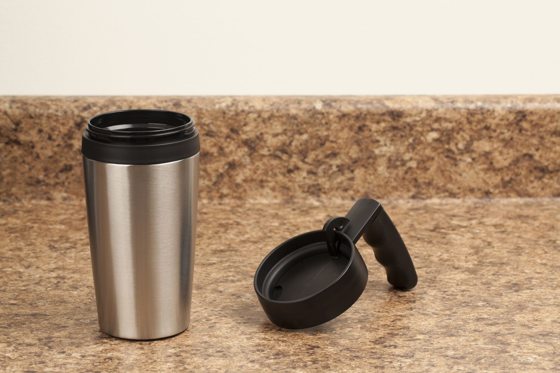 Stainless steel coffee travel mug, on kitchen counter