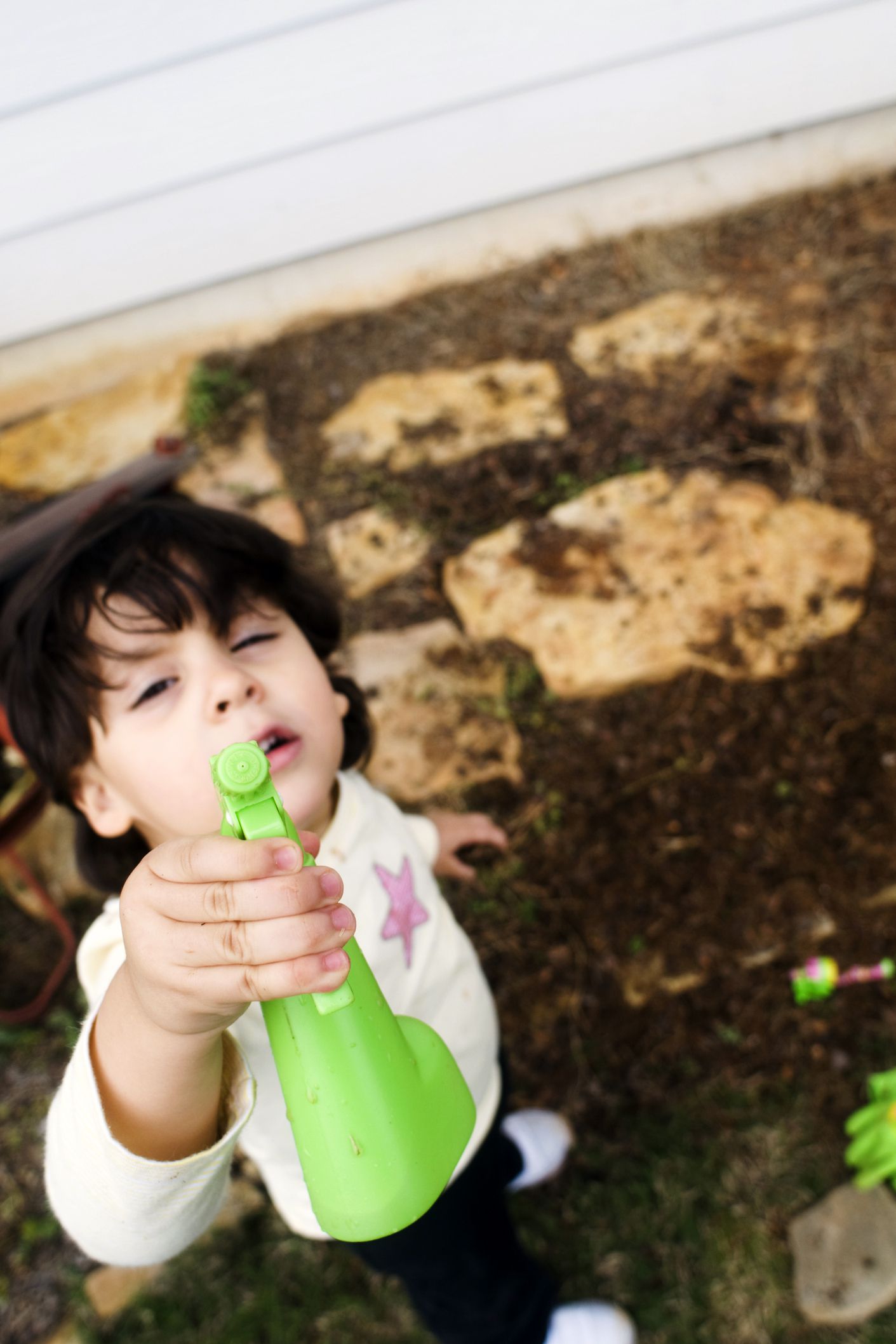 child holding spray bottle