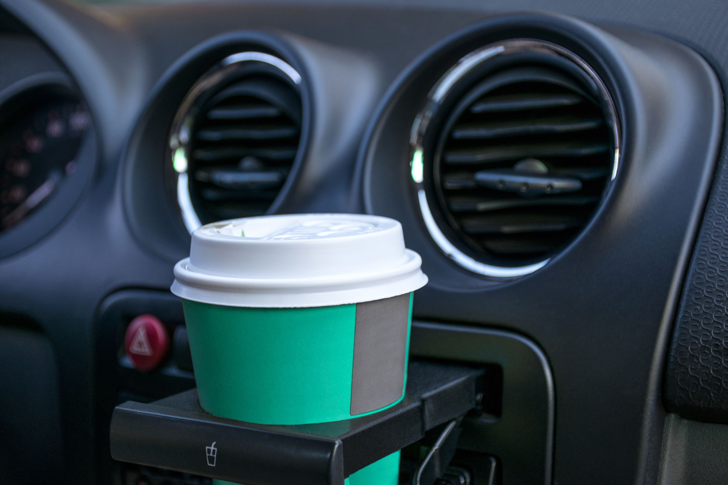 paper coffee cups inside car cup holder