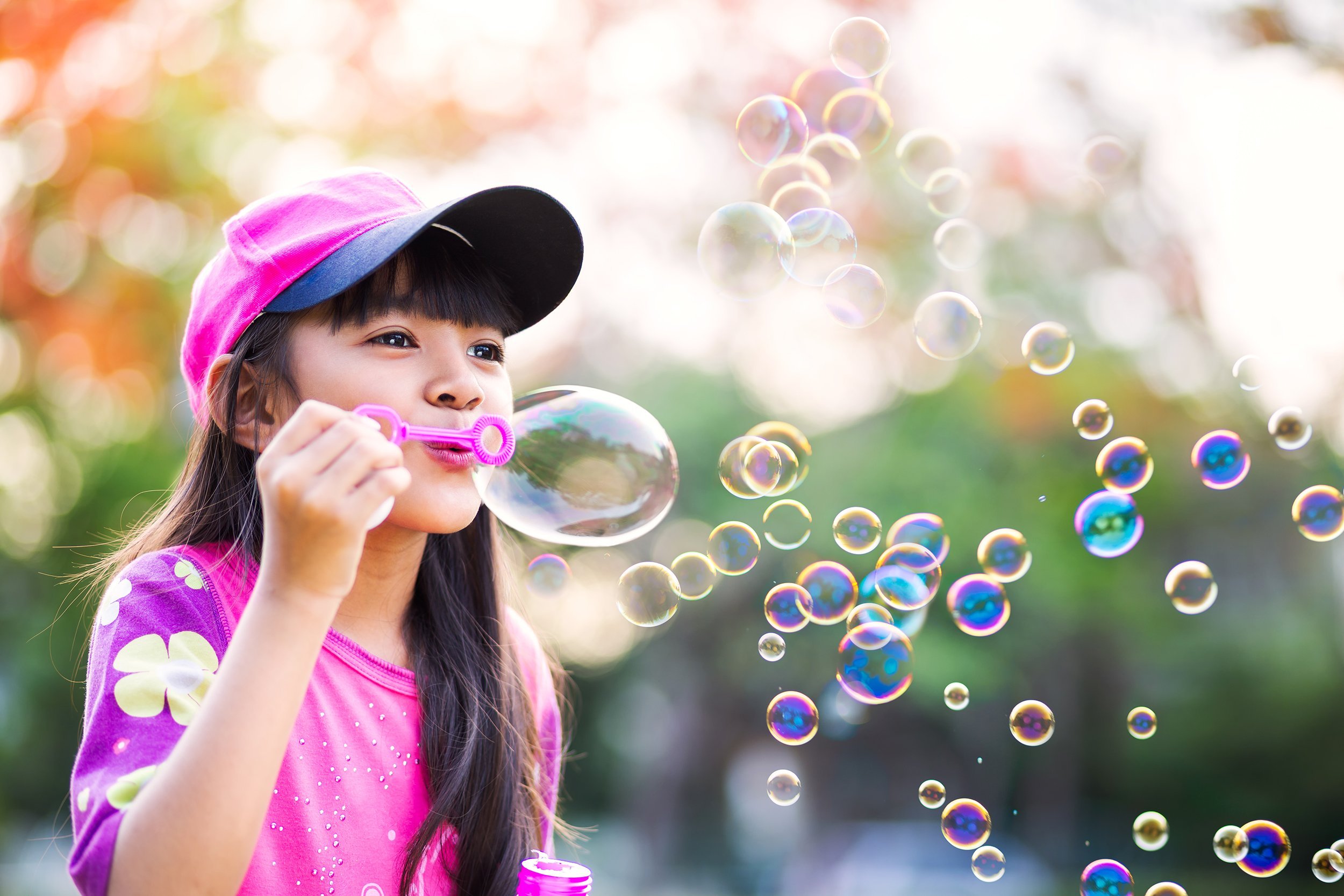 girl blowing bubbles
