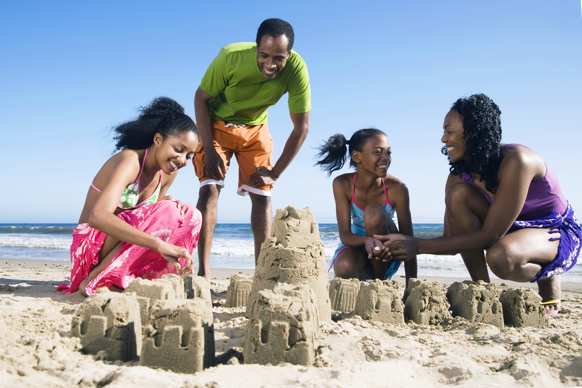 family building sandcastle on beach