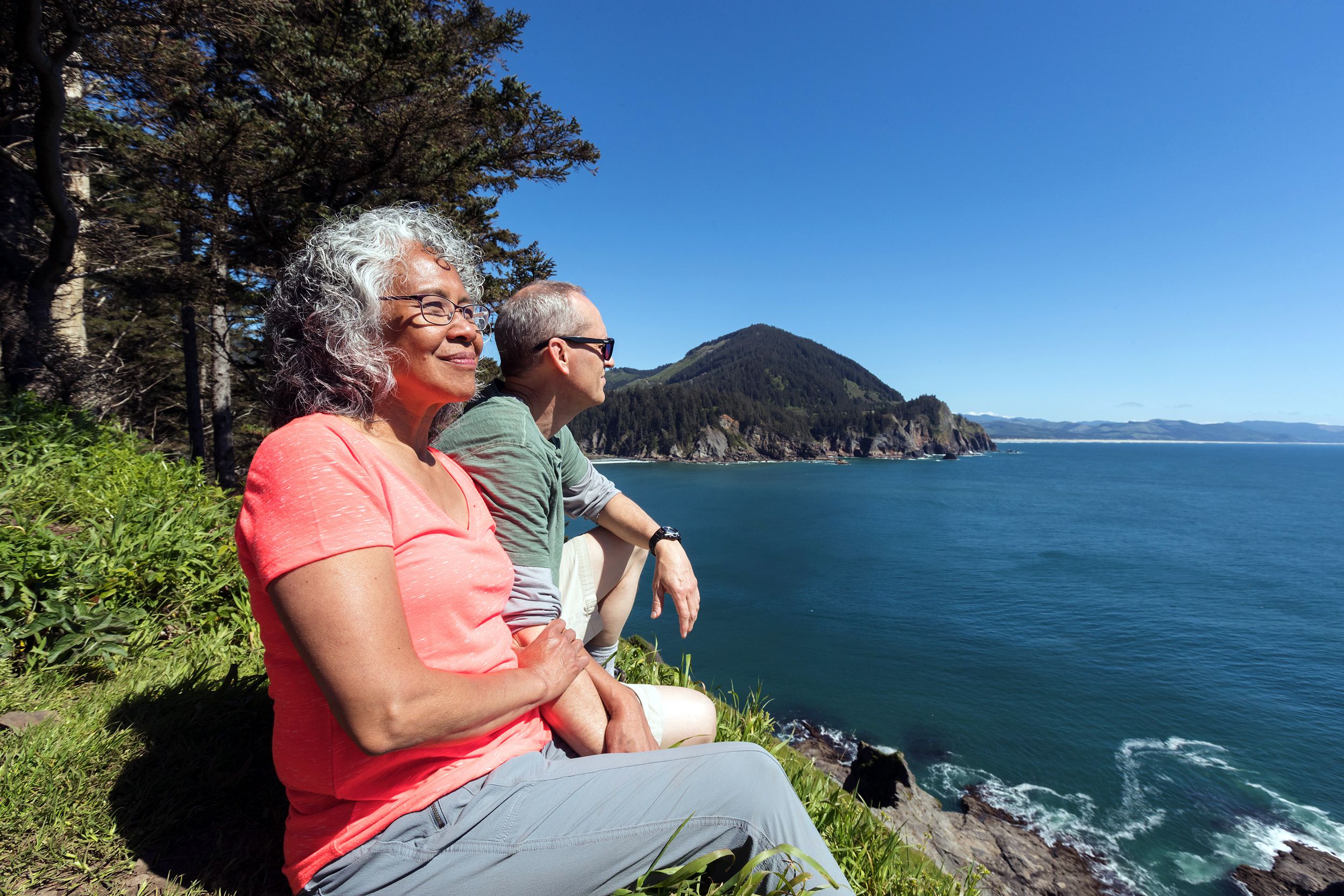 senior couple on the coast looking out to the sea