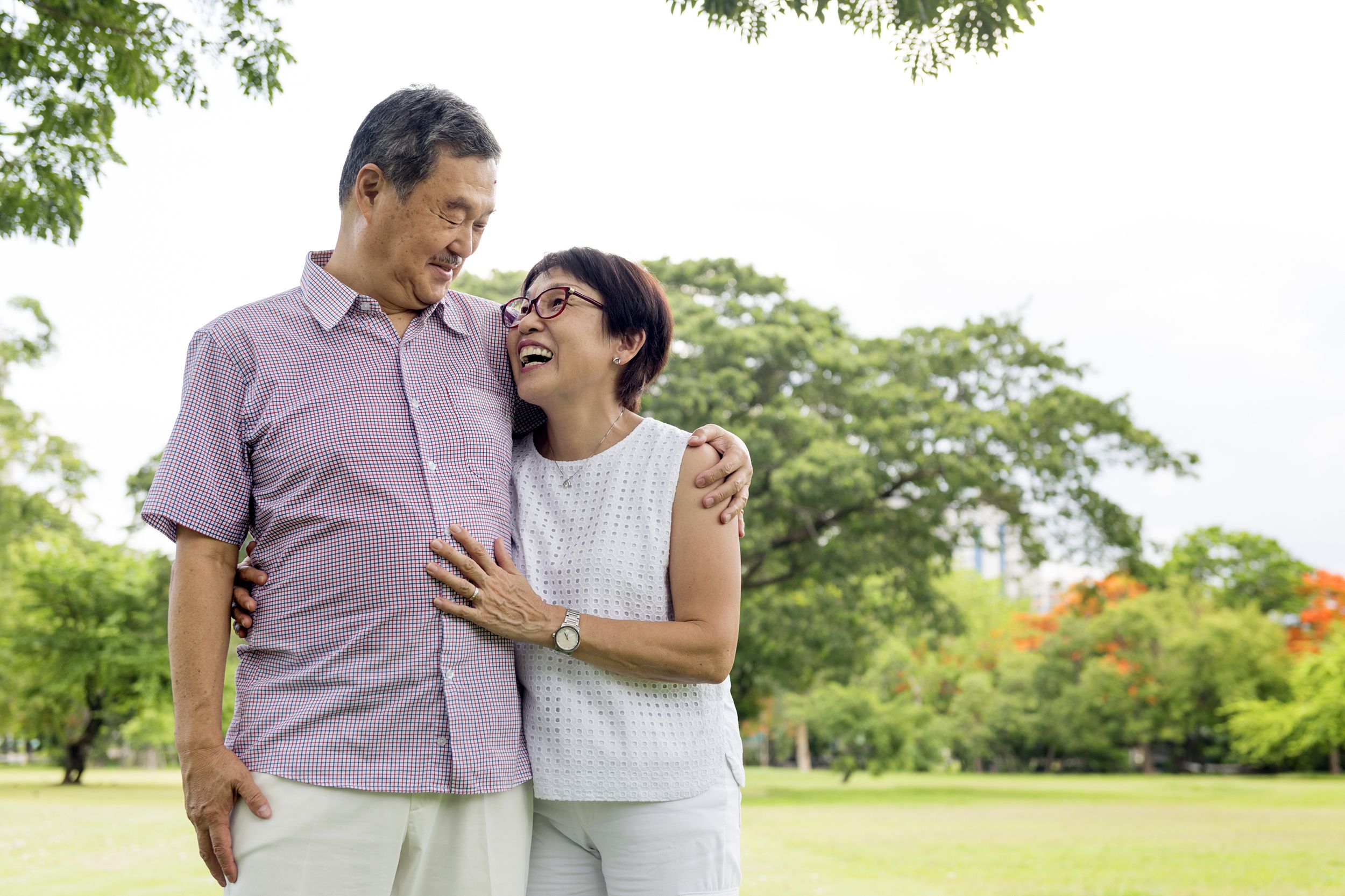 senior couple smiling in the park together