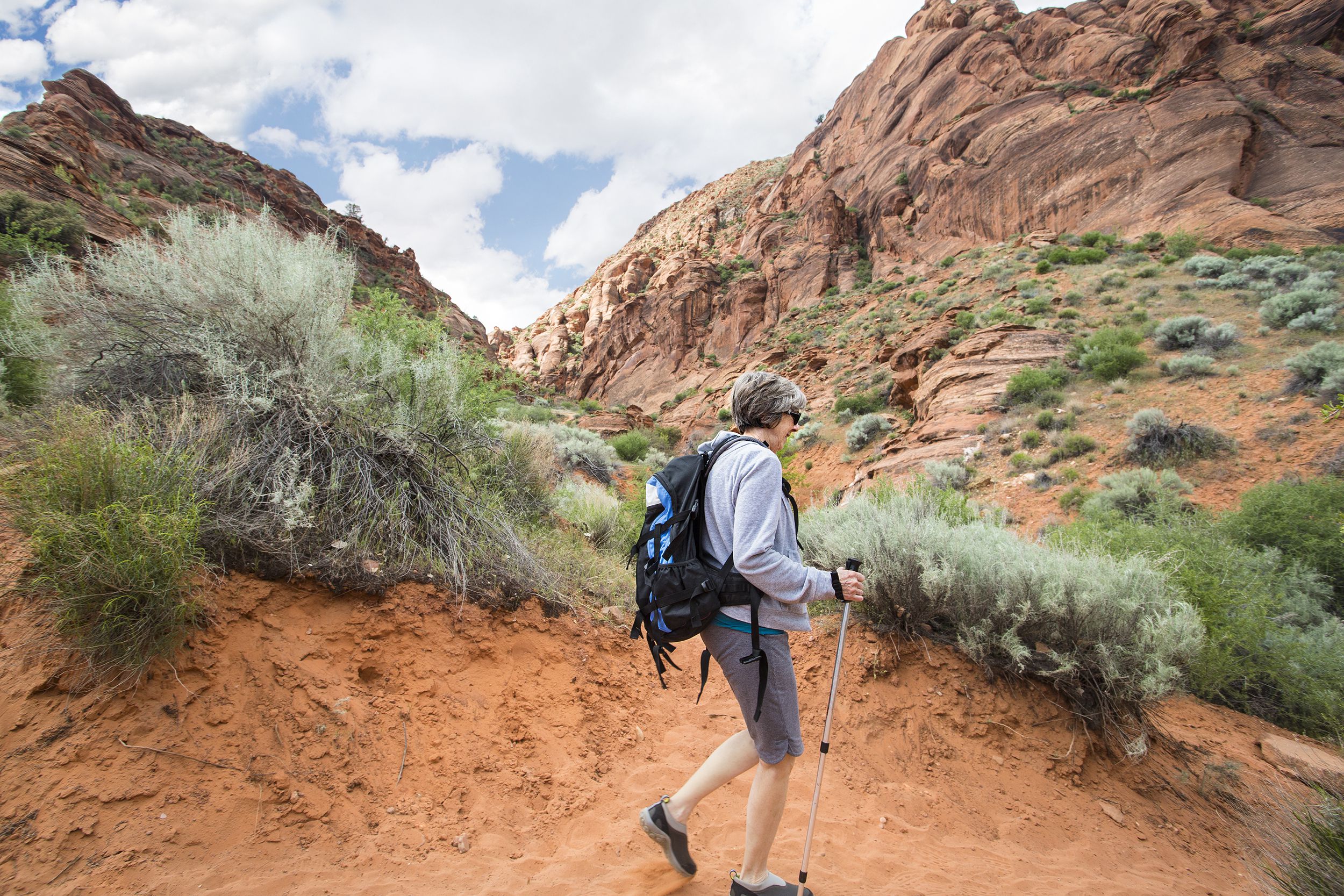 senior woman hiking in a beautiful Red Rock Canyon in Nevada