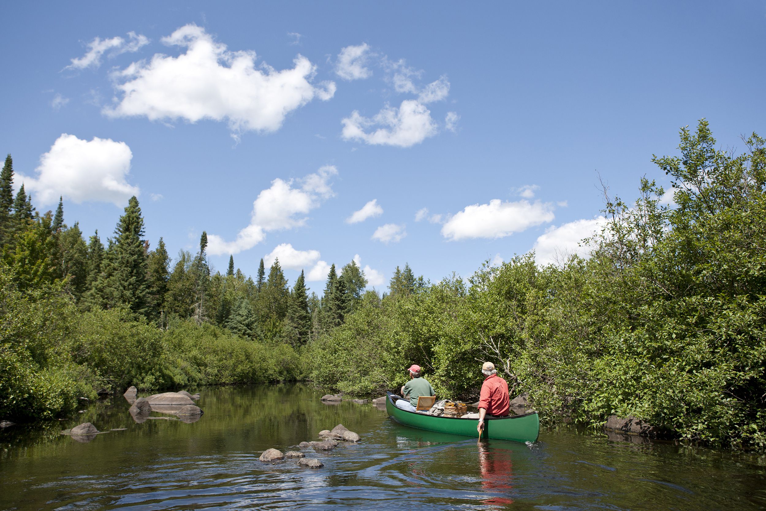 senior couple canoeing Wisconsin forest lake