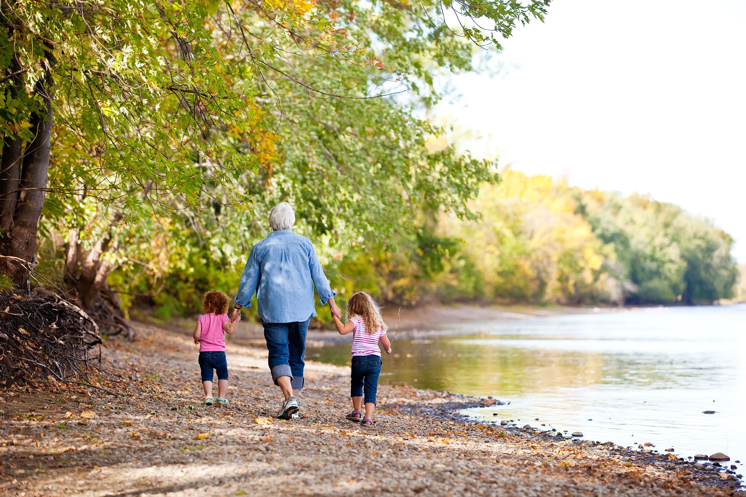 two girls and grandma walking by river in Mississippi