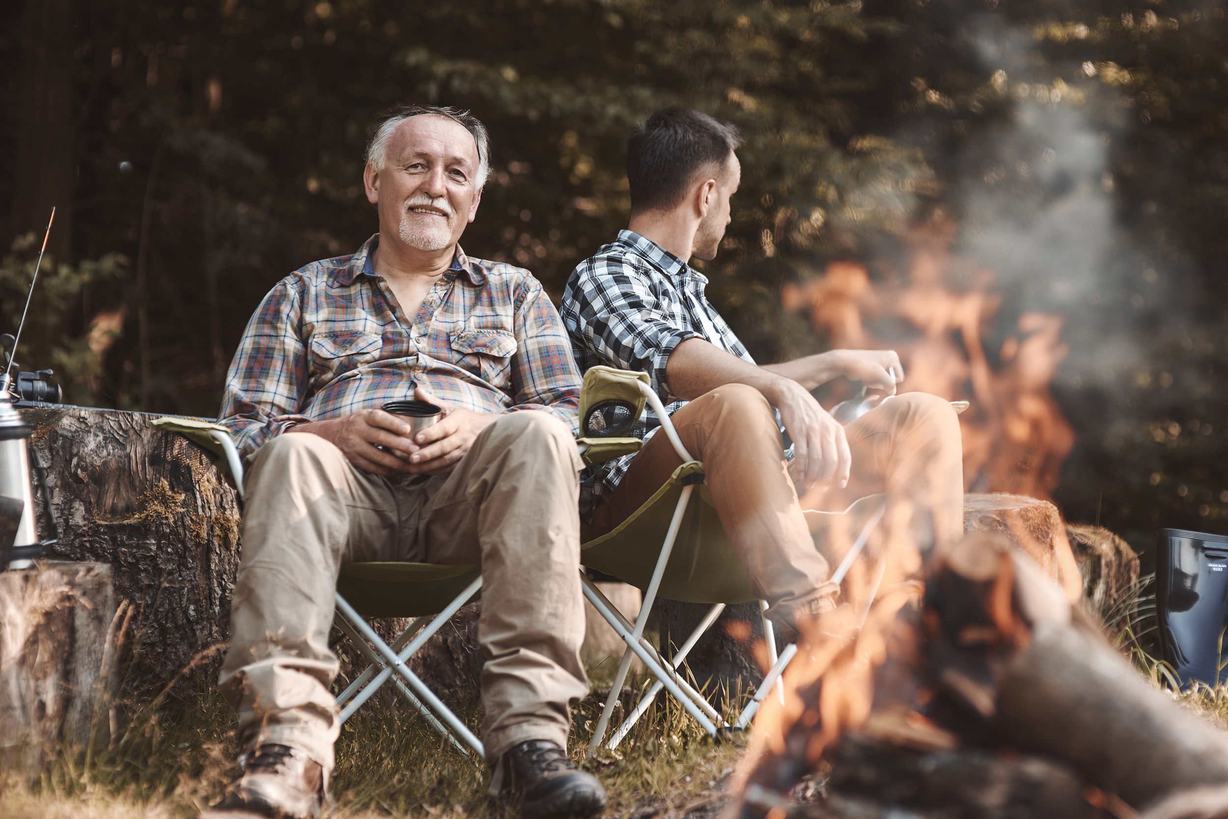 senior father with son camping outside