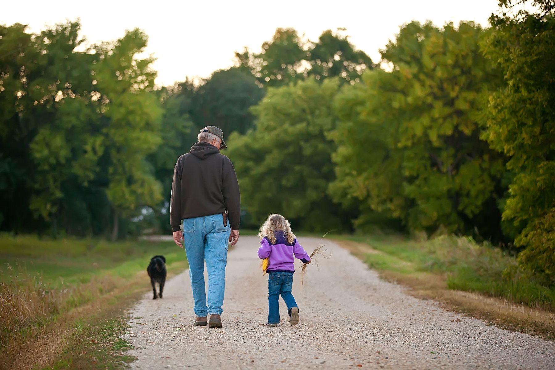 grandpa with granddaughter on dirt road