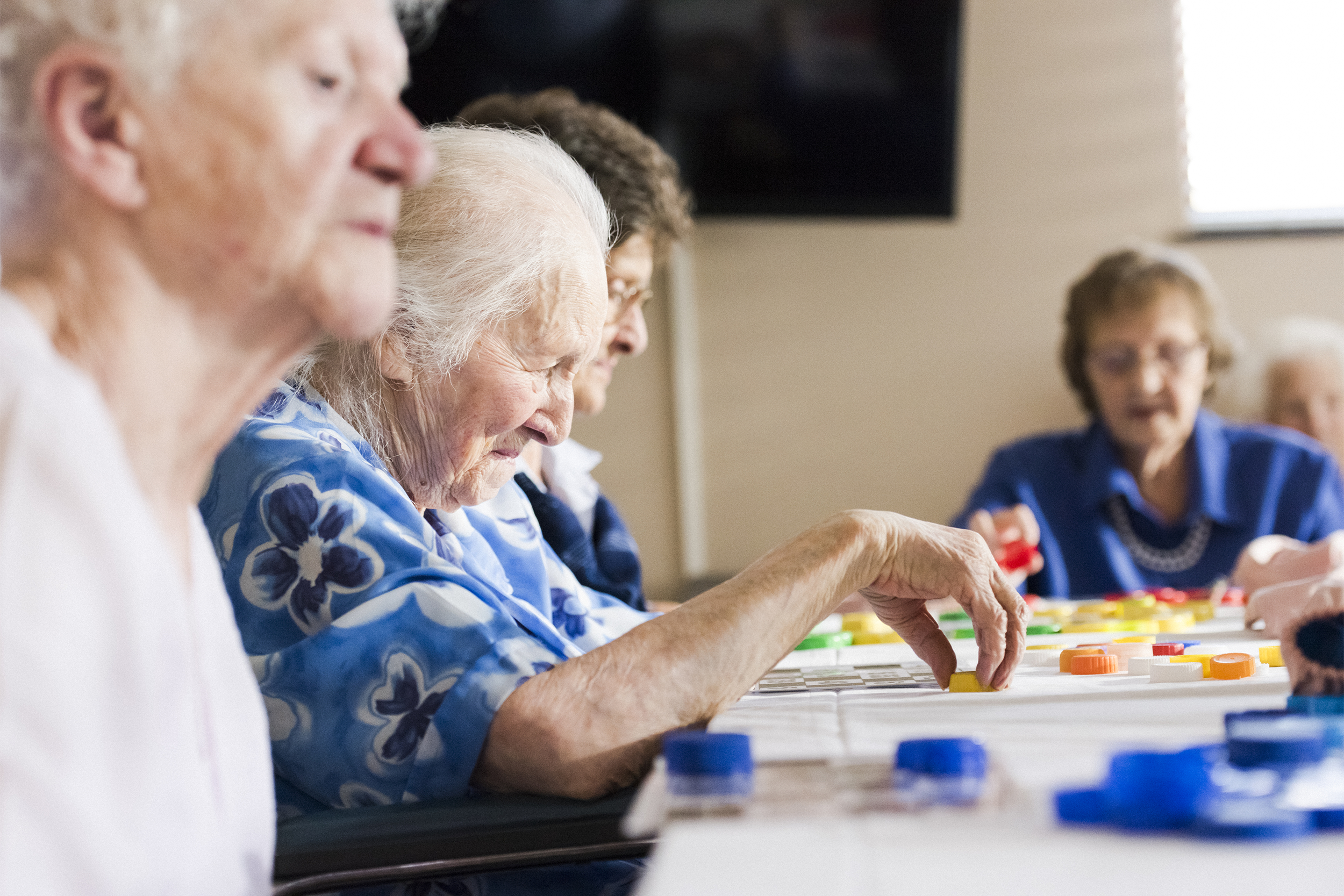 Senior ladies at a table playing bingo