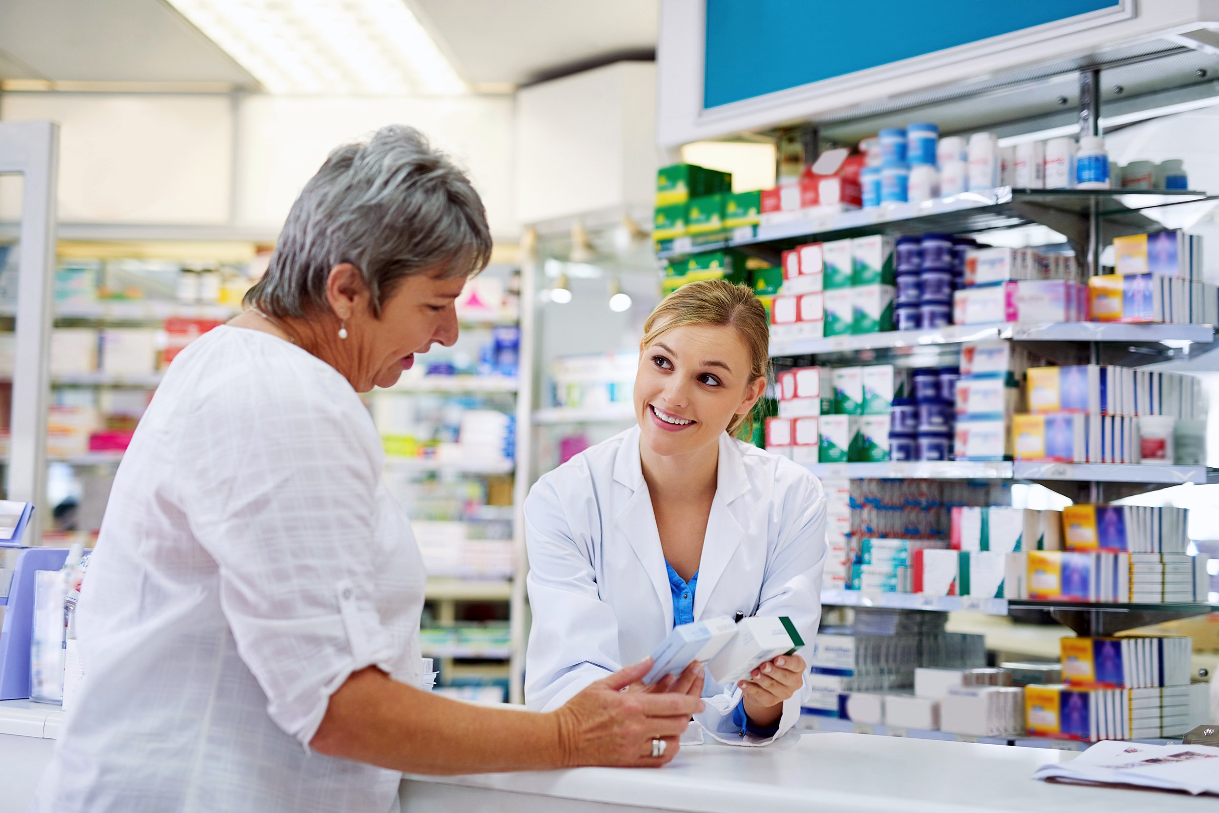Woman at the pharmacy talking about medicine with pharmacist