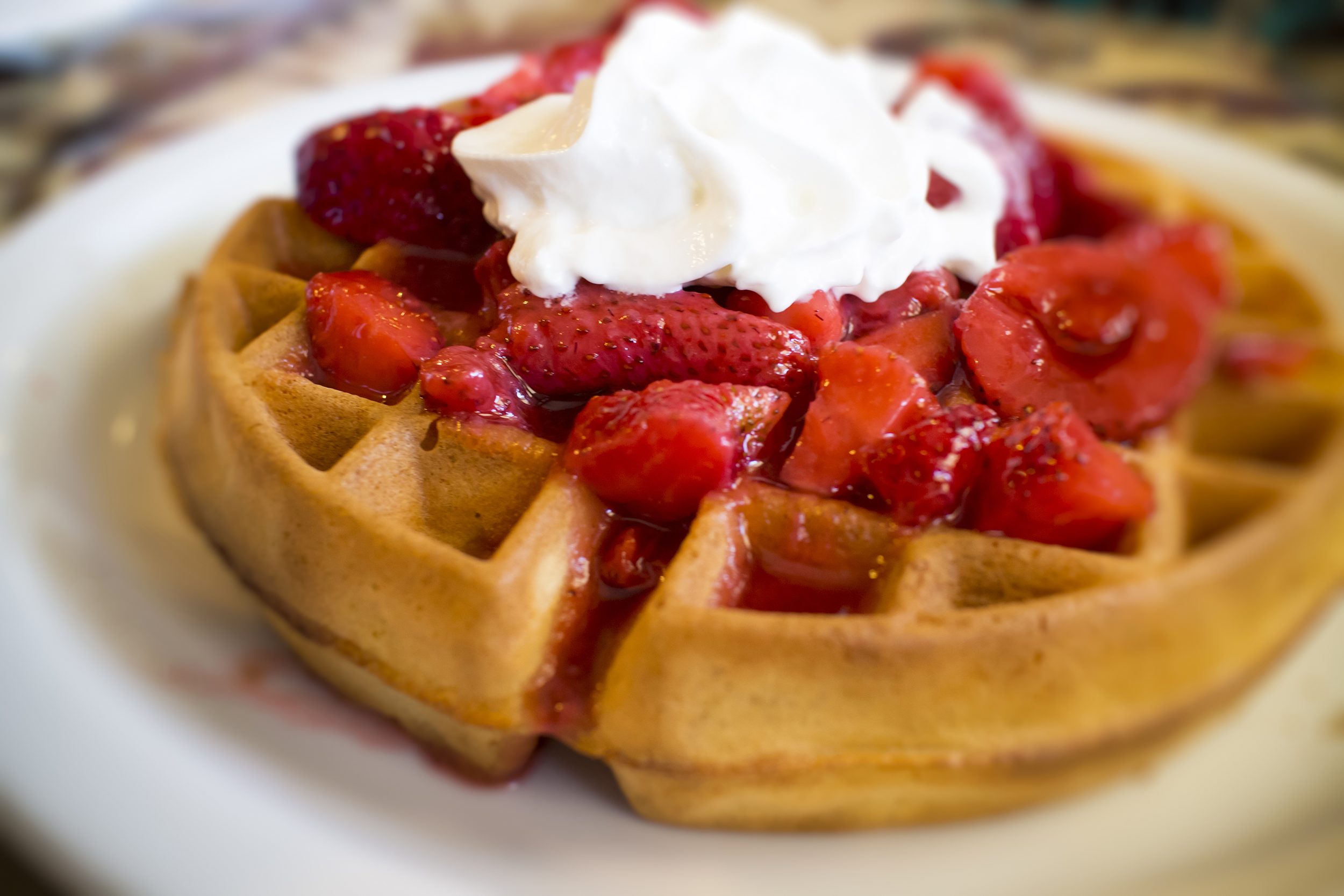 Belgian waffle with strawberries and whipped cream