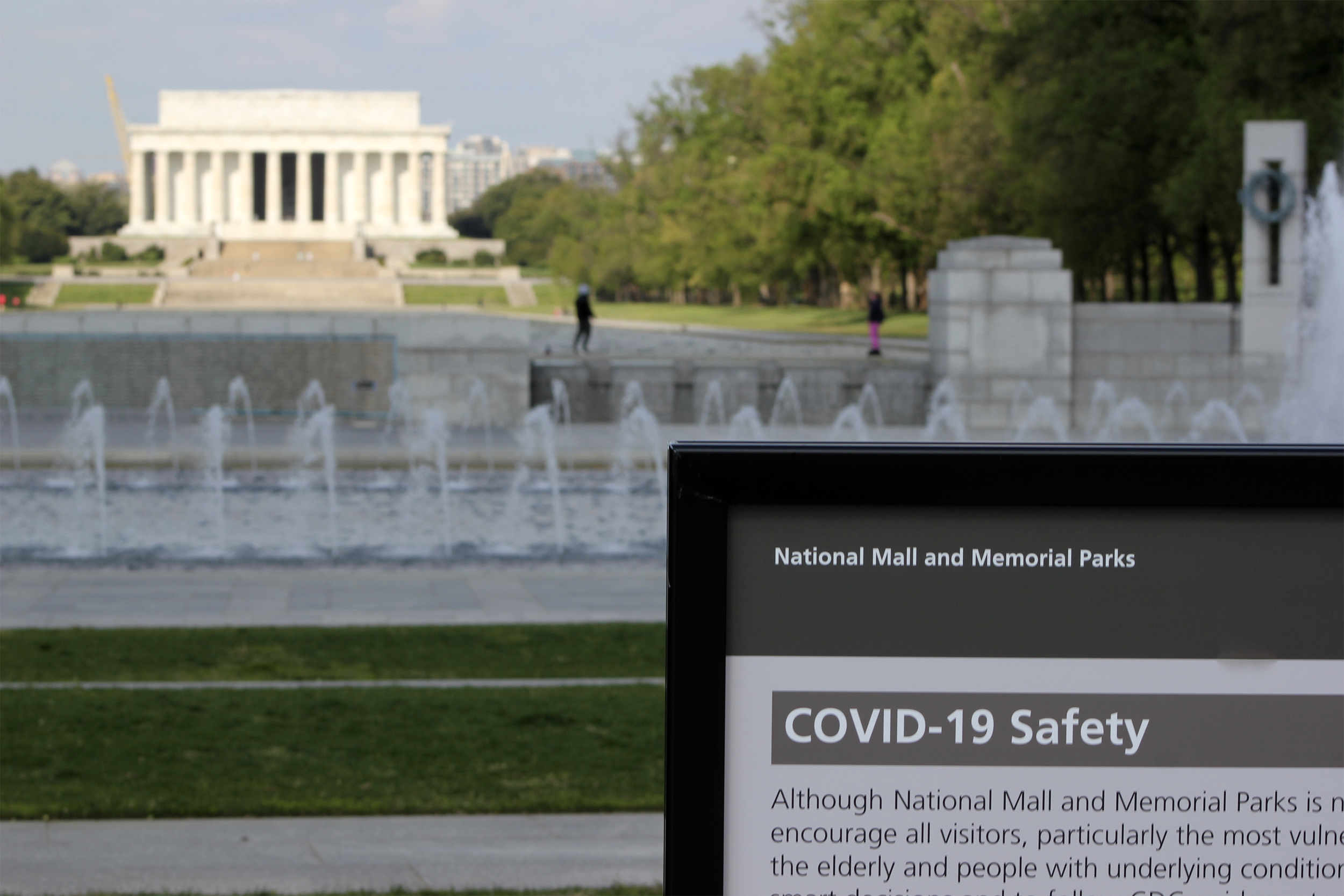 A warning sign stands among usually crowded tourist attractions in Washington DC