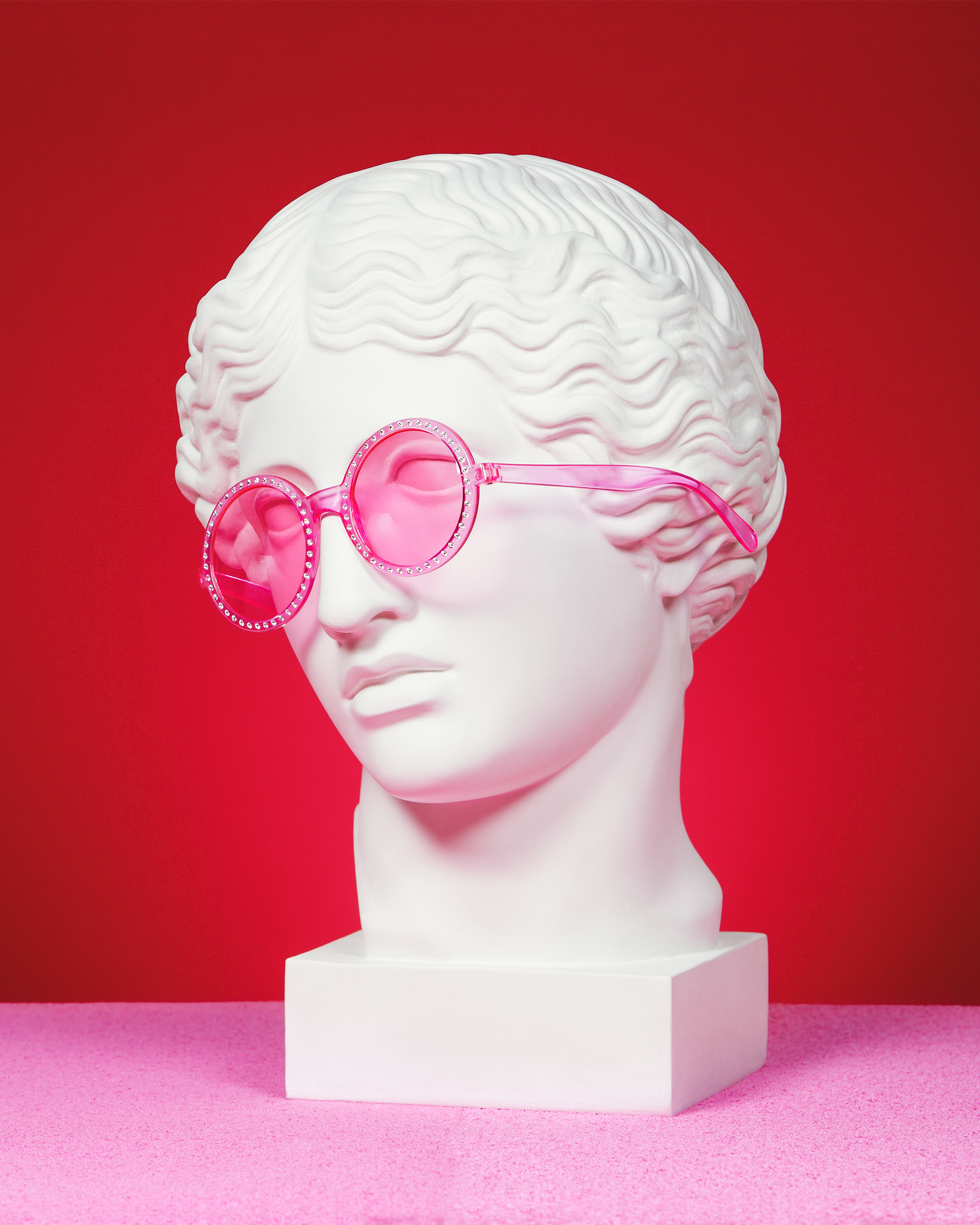 statue head wearing pink sunglasses