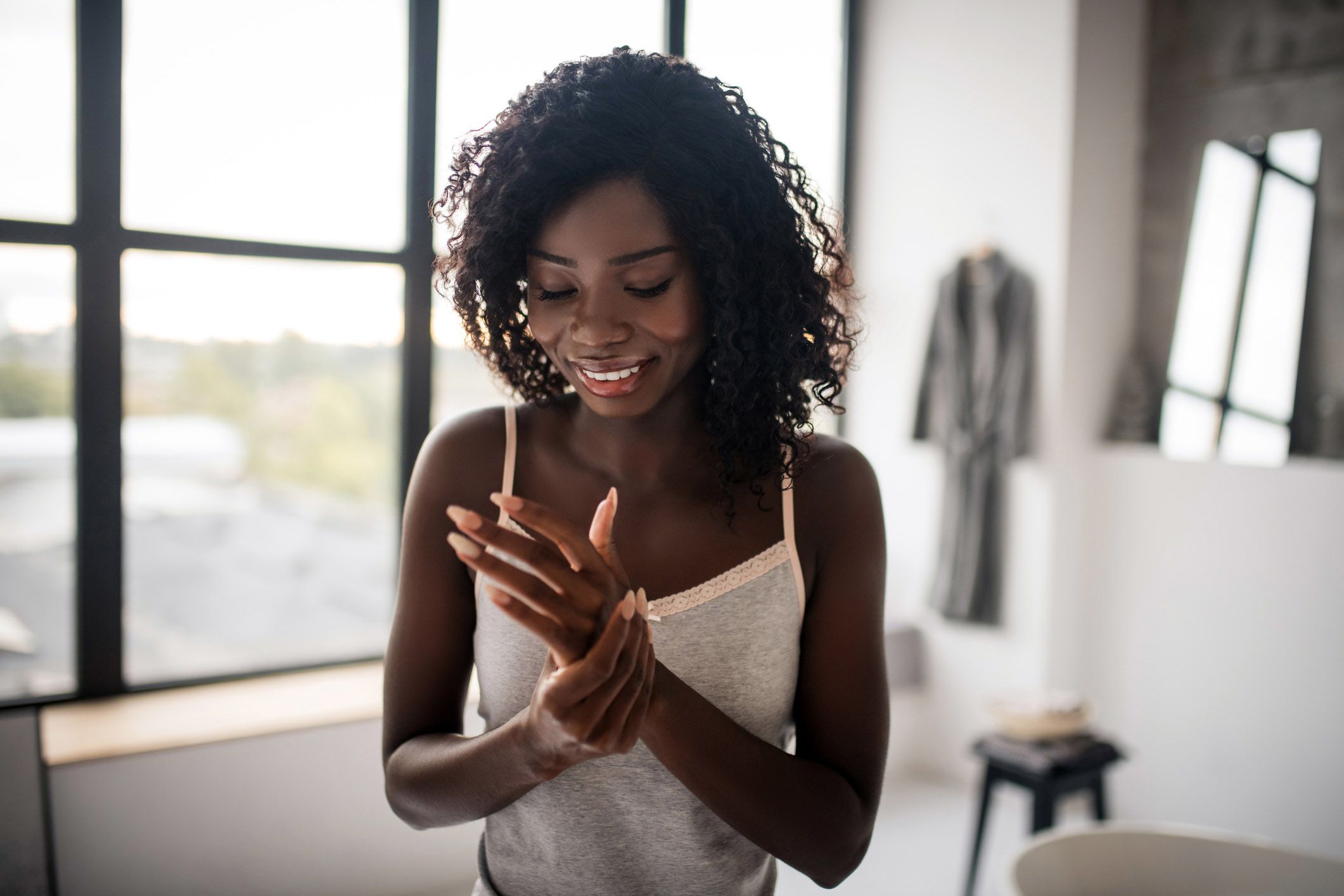 woman putting on hand lotion