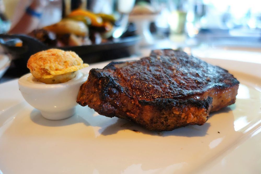 dry aged bone-in new york – medium rare, gougere, a5 wagyu tallow butter