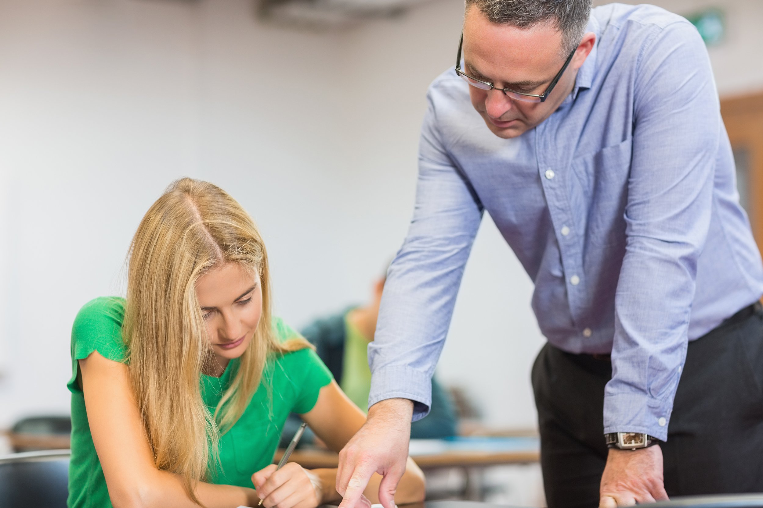 teacher with student in the classroom