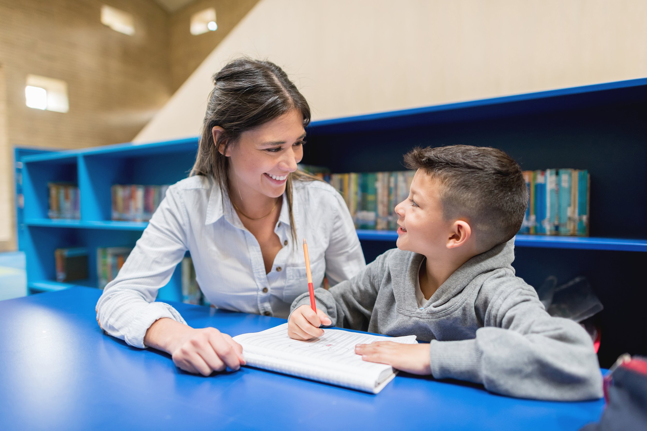 teacher with a student at the library
