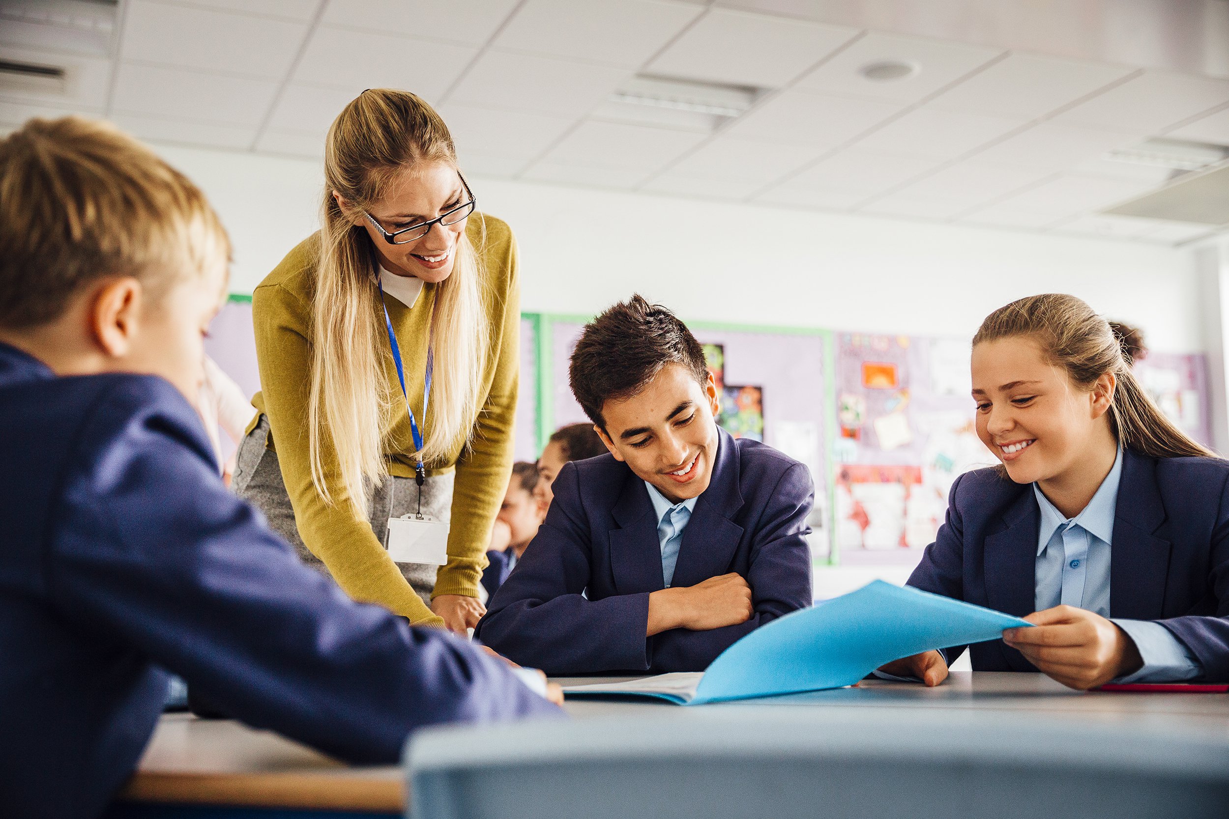 teacher with students in high school classroom