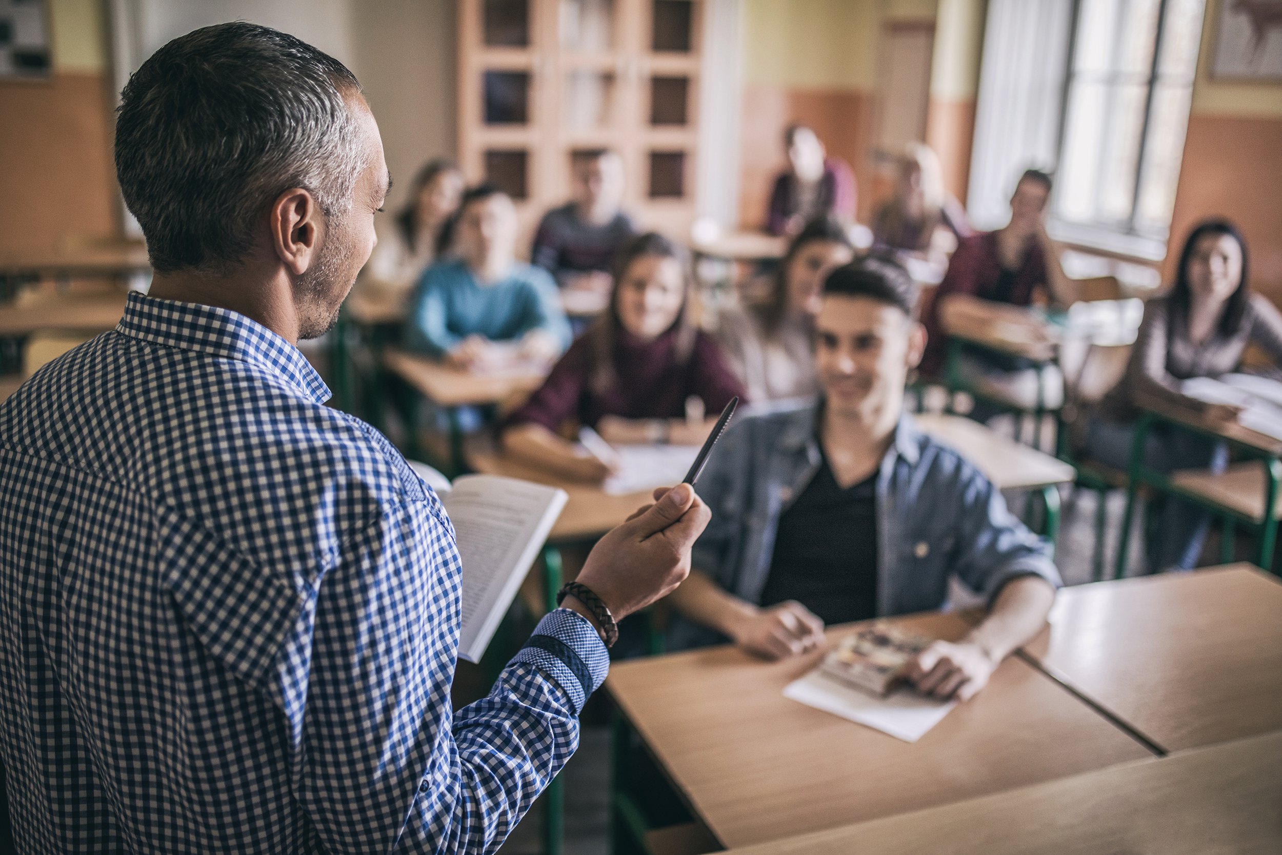 high school teacher giving a lecture in the classroom