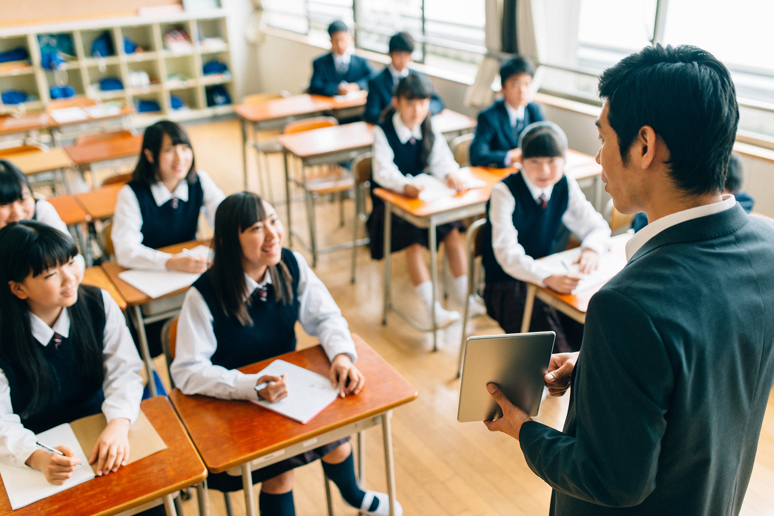 teacher and students using digital tablet in Japanese school