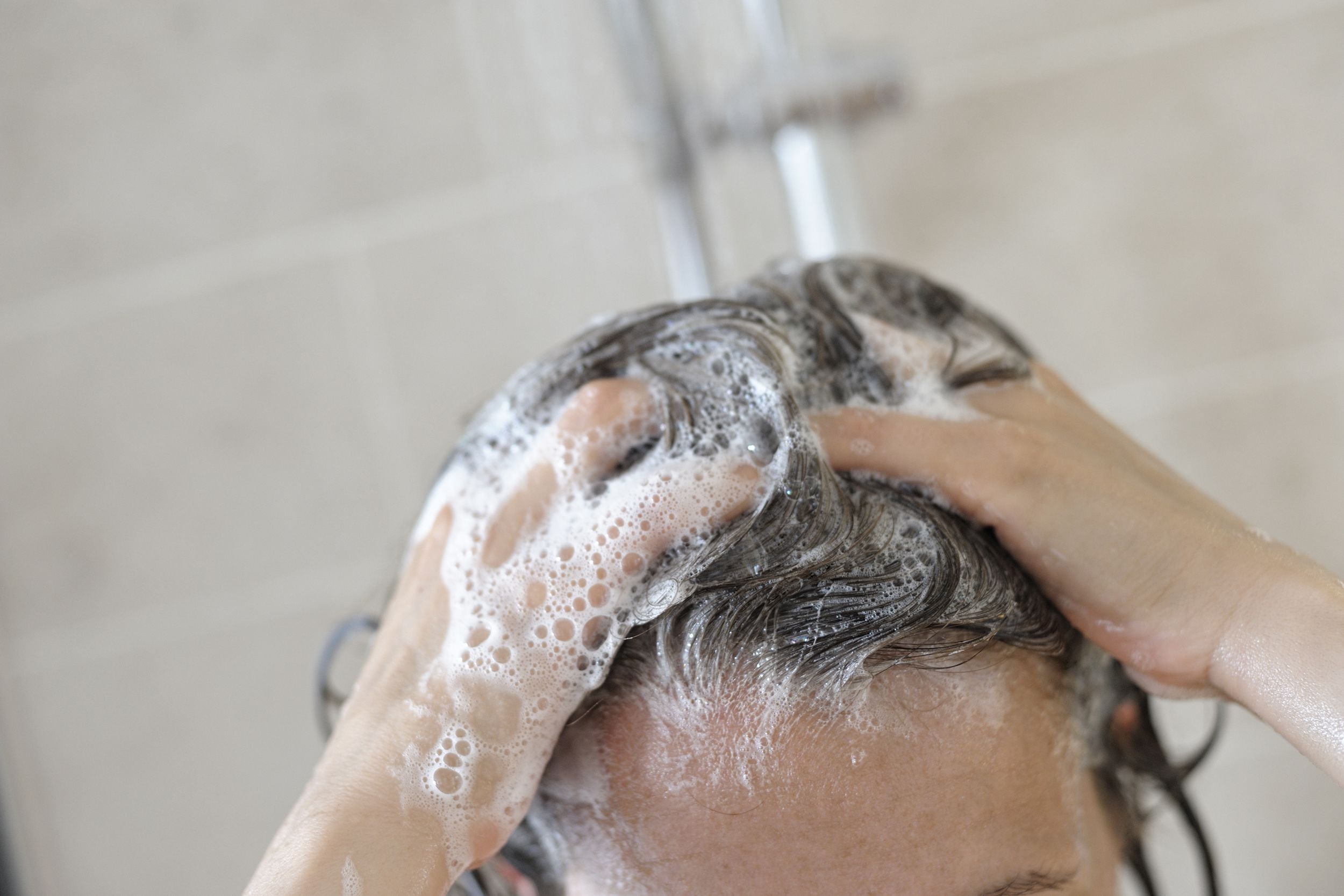 woman in shower washing her hair