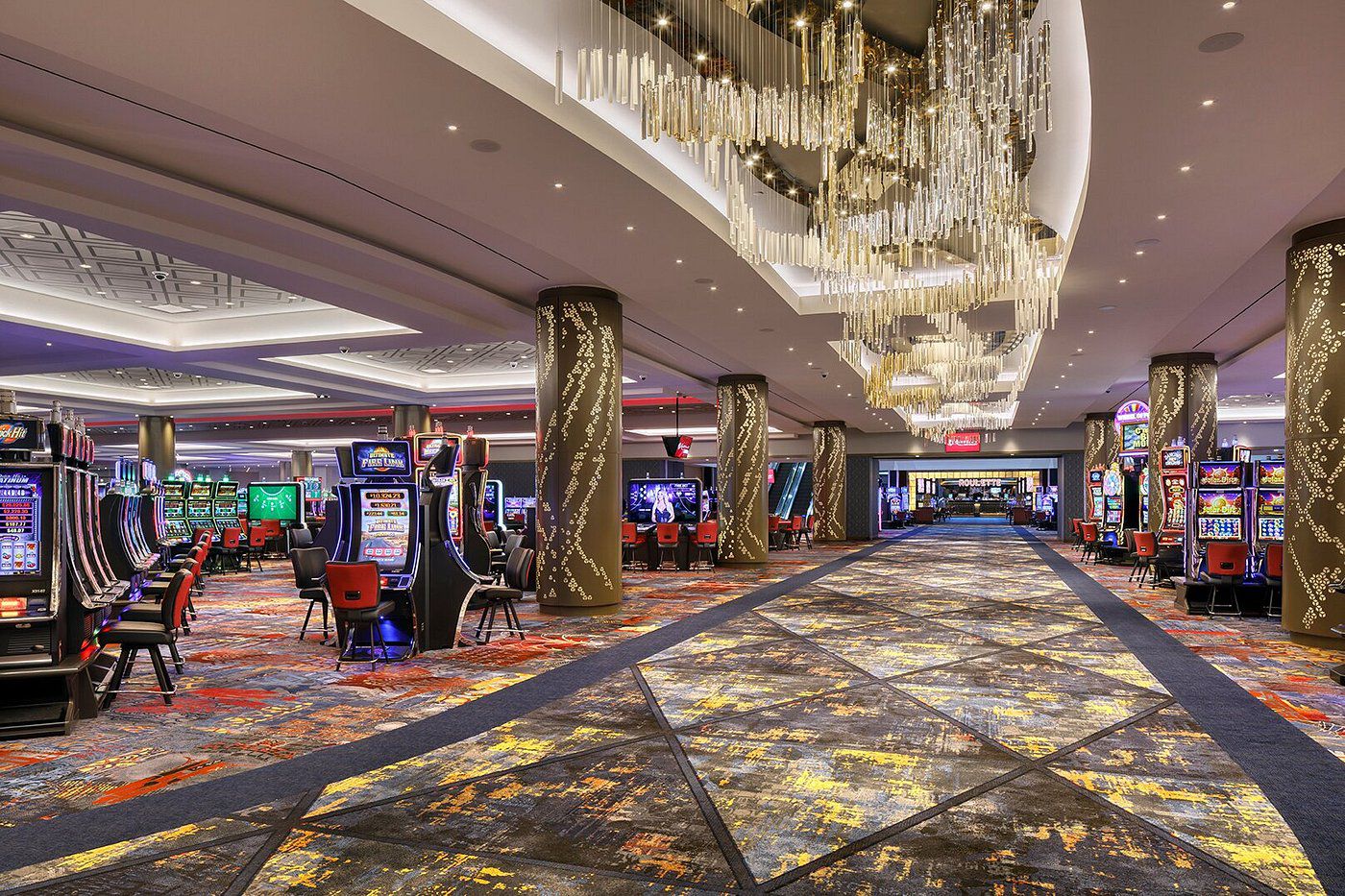 Resort World Casino New York City, Queens, New York, casino room with slot machines and chairs, liquid chandelier lights