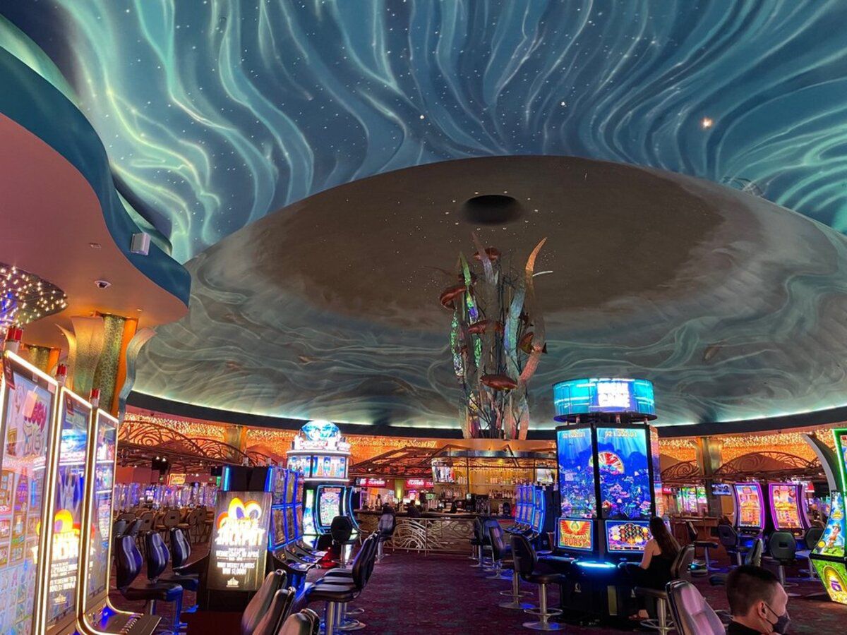 Tulalip Casino, Tulalip, Washington, inside the casino, blue oceanic ceiling, several slot machines and seating for them
