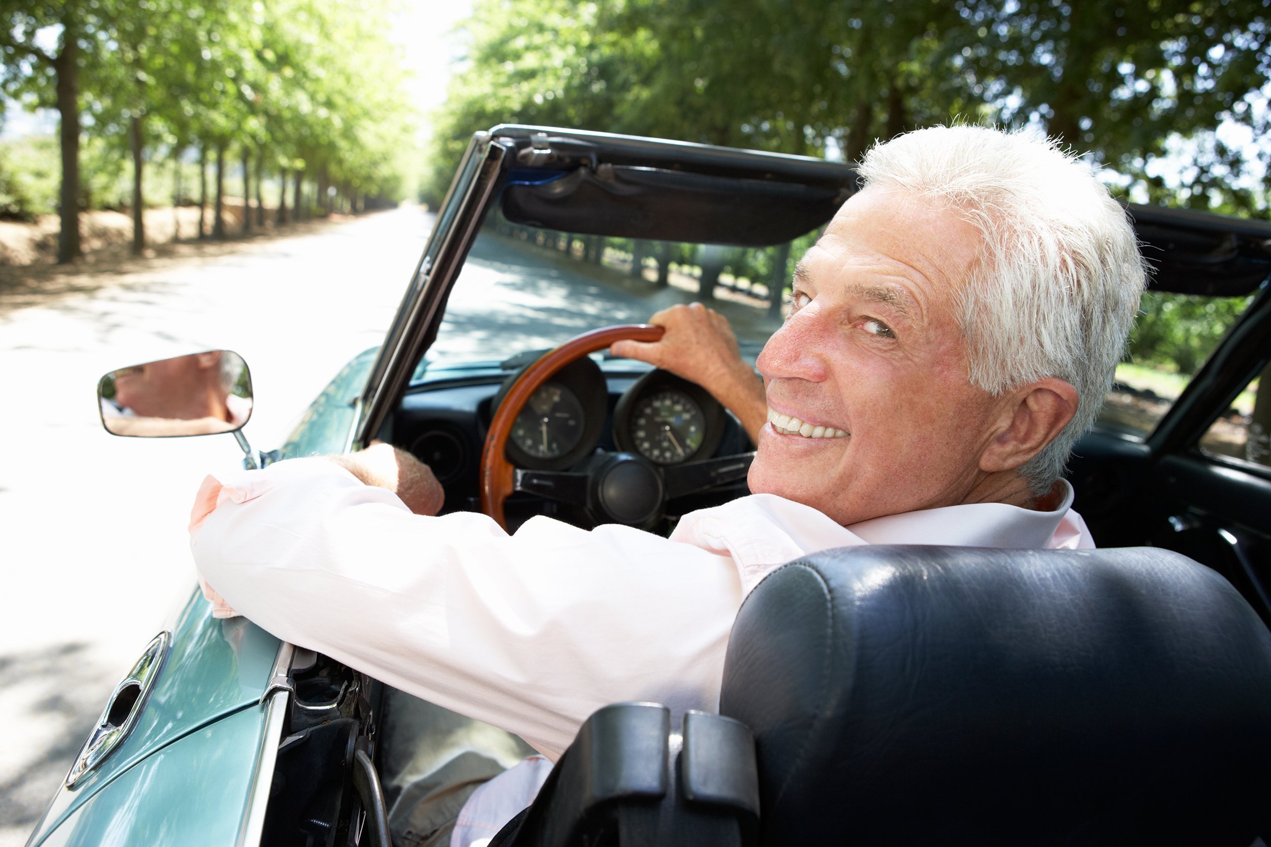 senior man in sports car