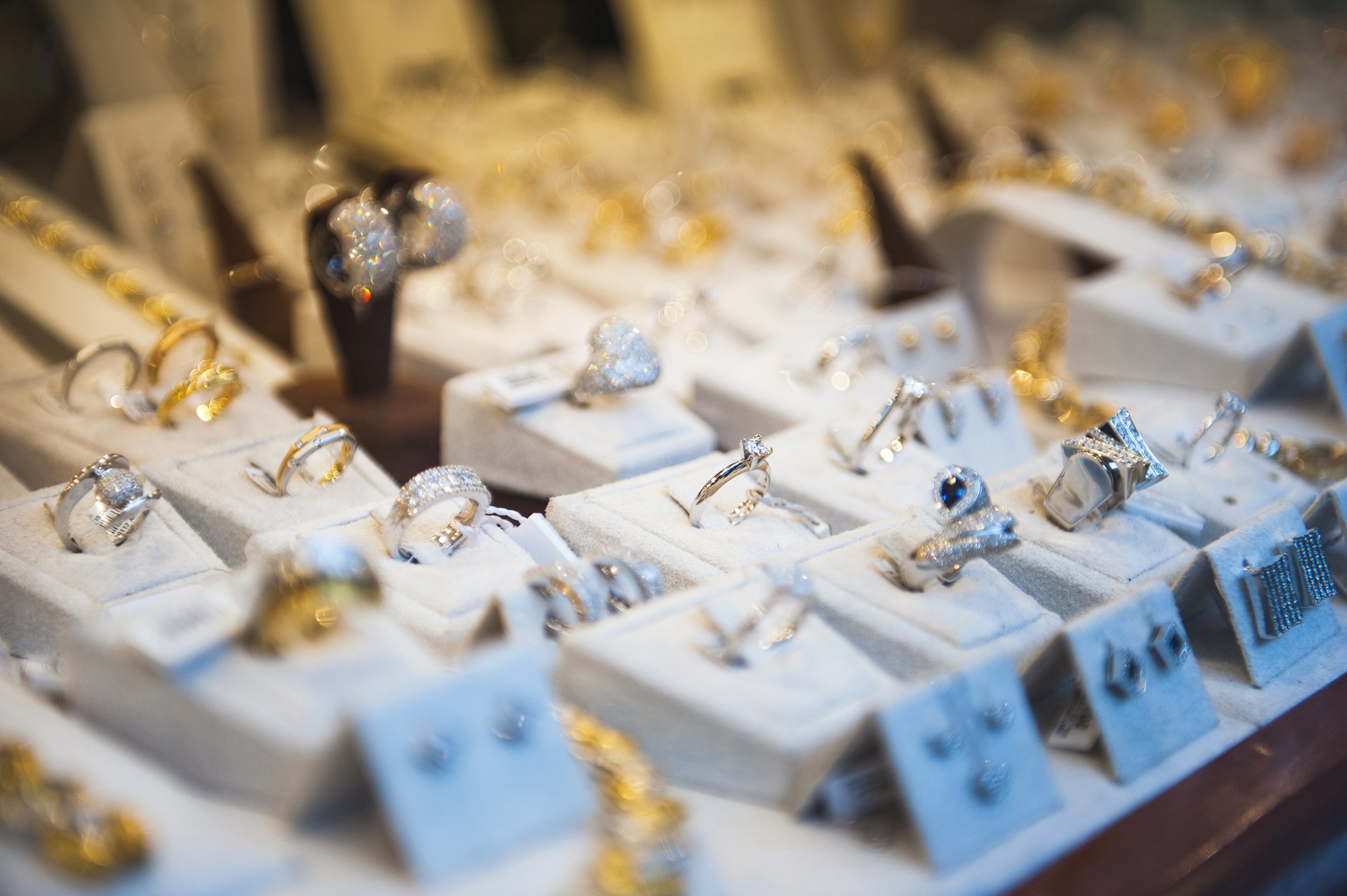 window display at jewelry shop presenting necklace, rings, and earring sets