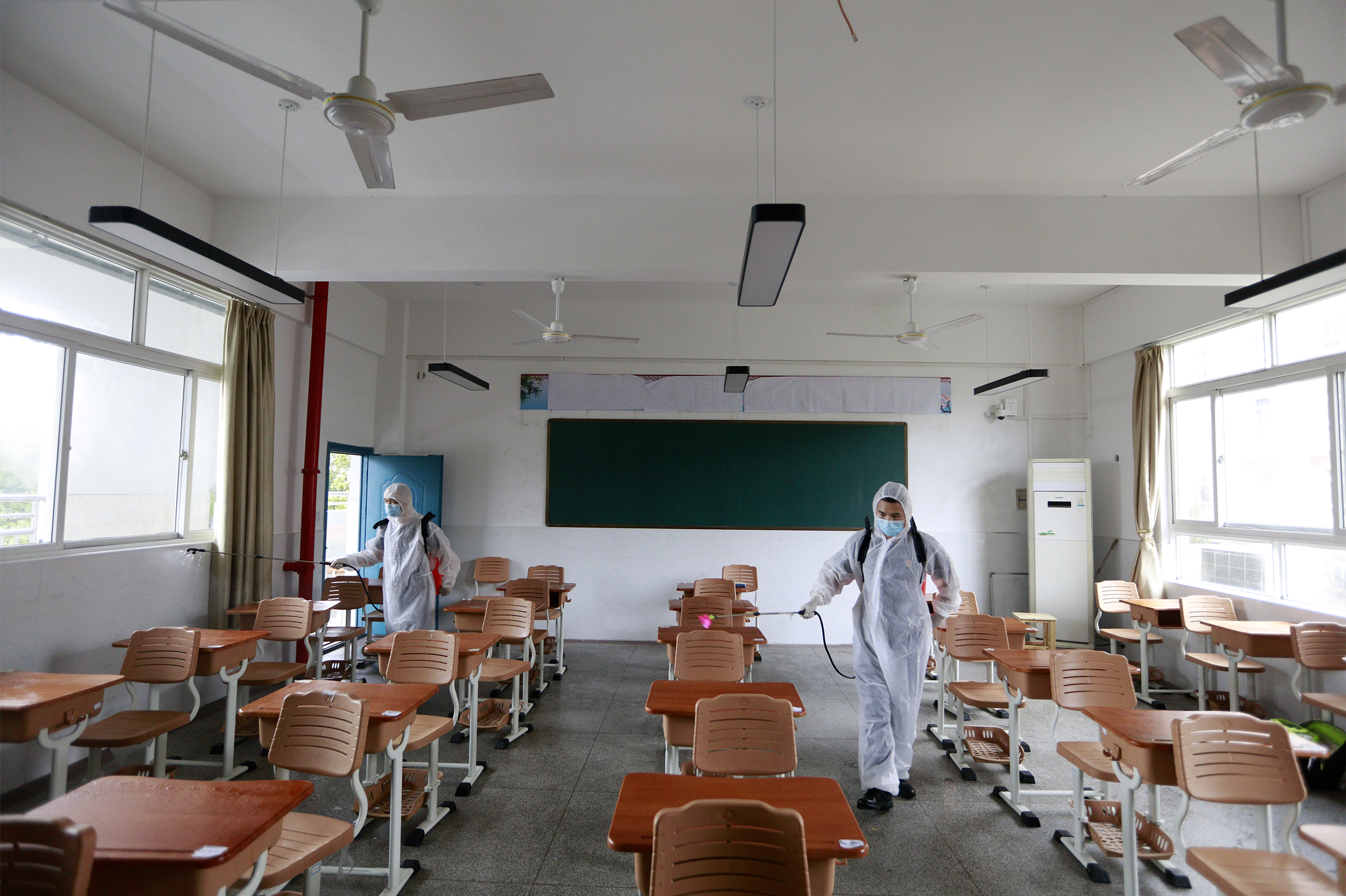 The workers are doing the sterilization and disinfection for the coming college entrance examination in Wuhan, Hubei,China