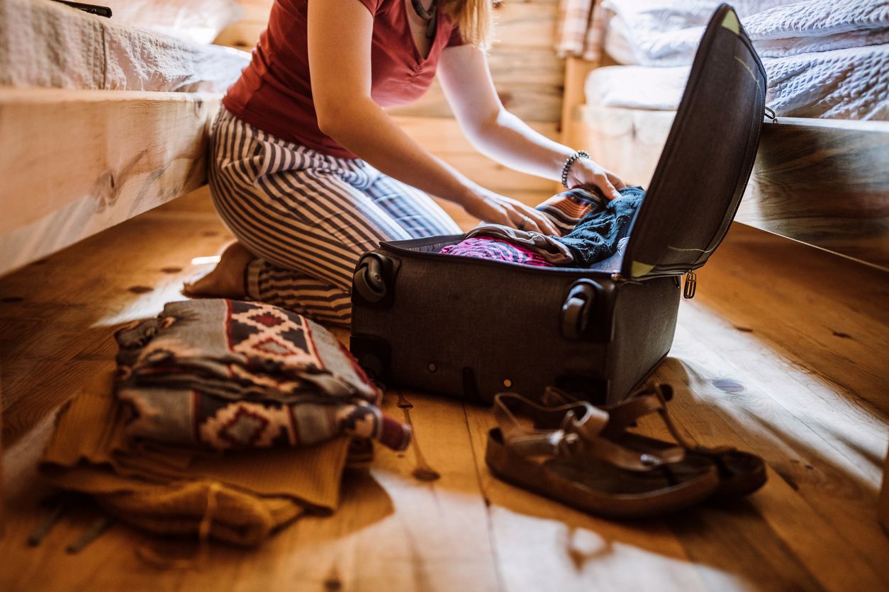 woman unpacking suitcase