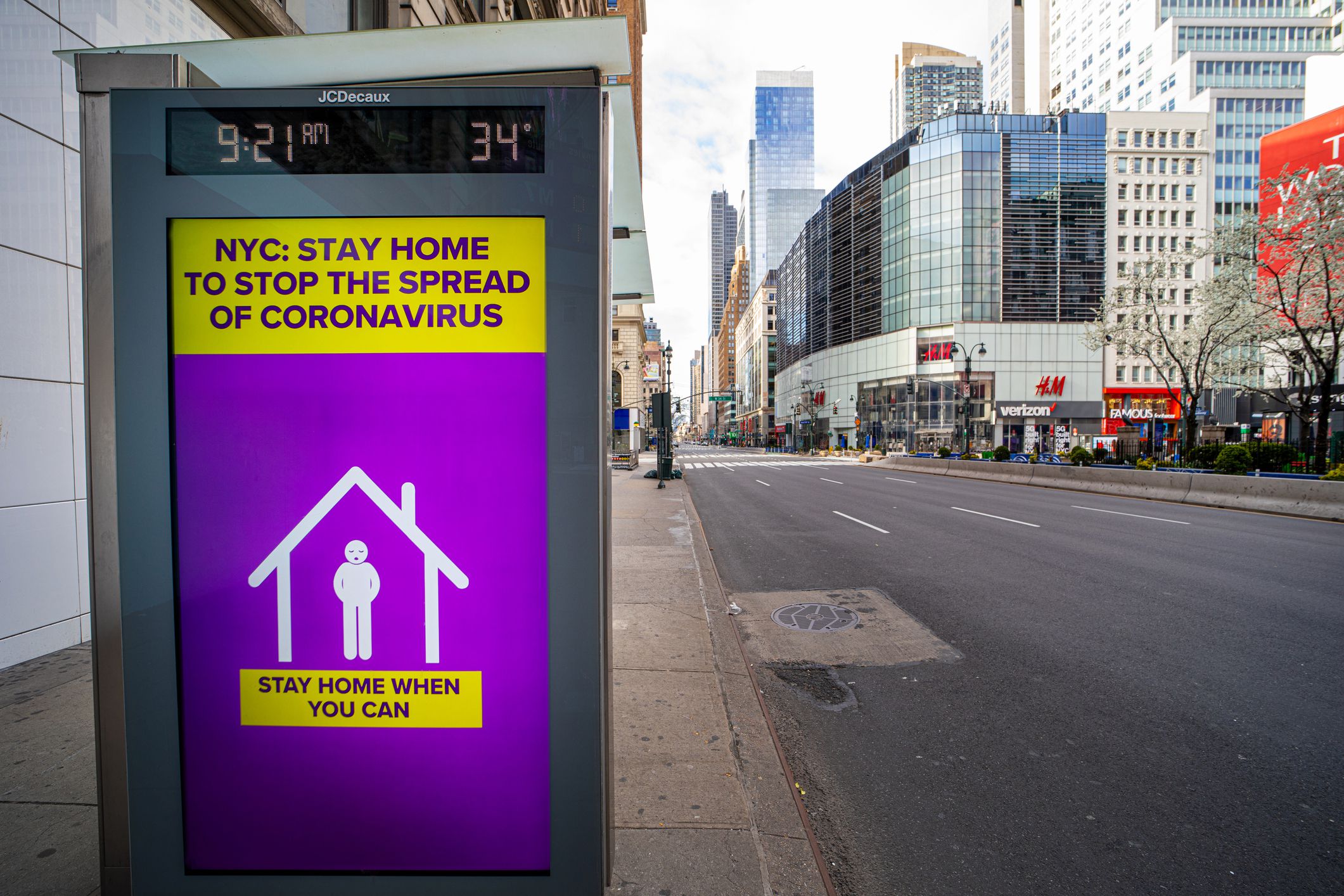 Advertisement for stopping the spread of Coronavirus on small billboard on bus stop in New York City Manhattan 34th Street
