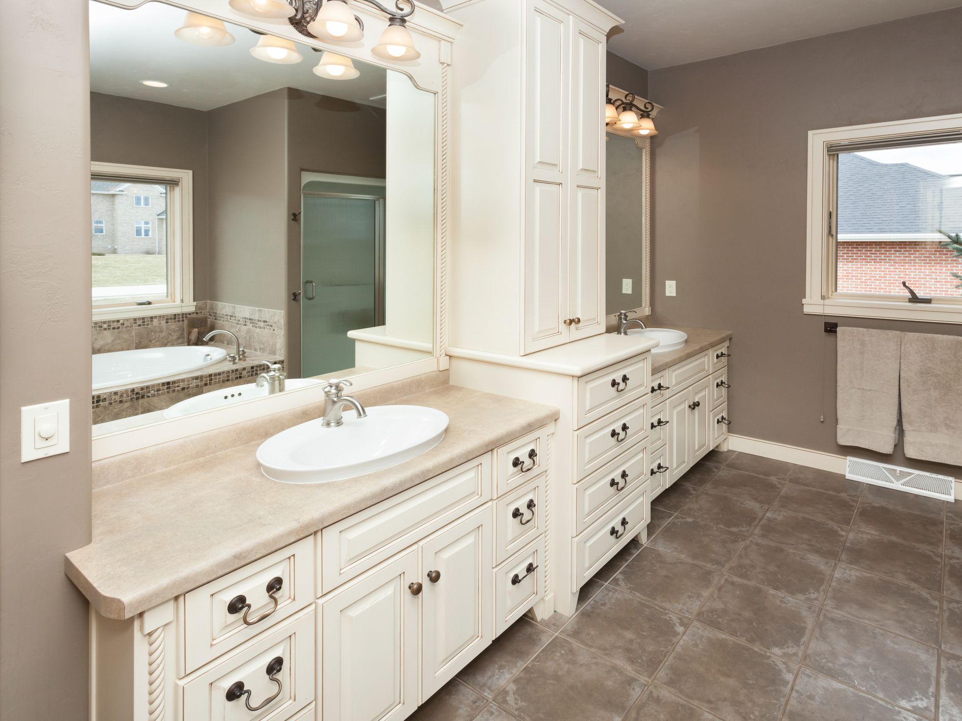Spacious Bathroom With Custom Cabinetry and Tile Floor