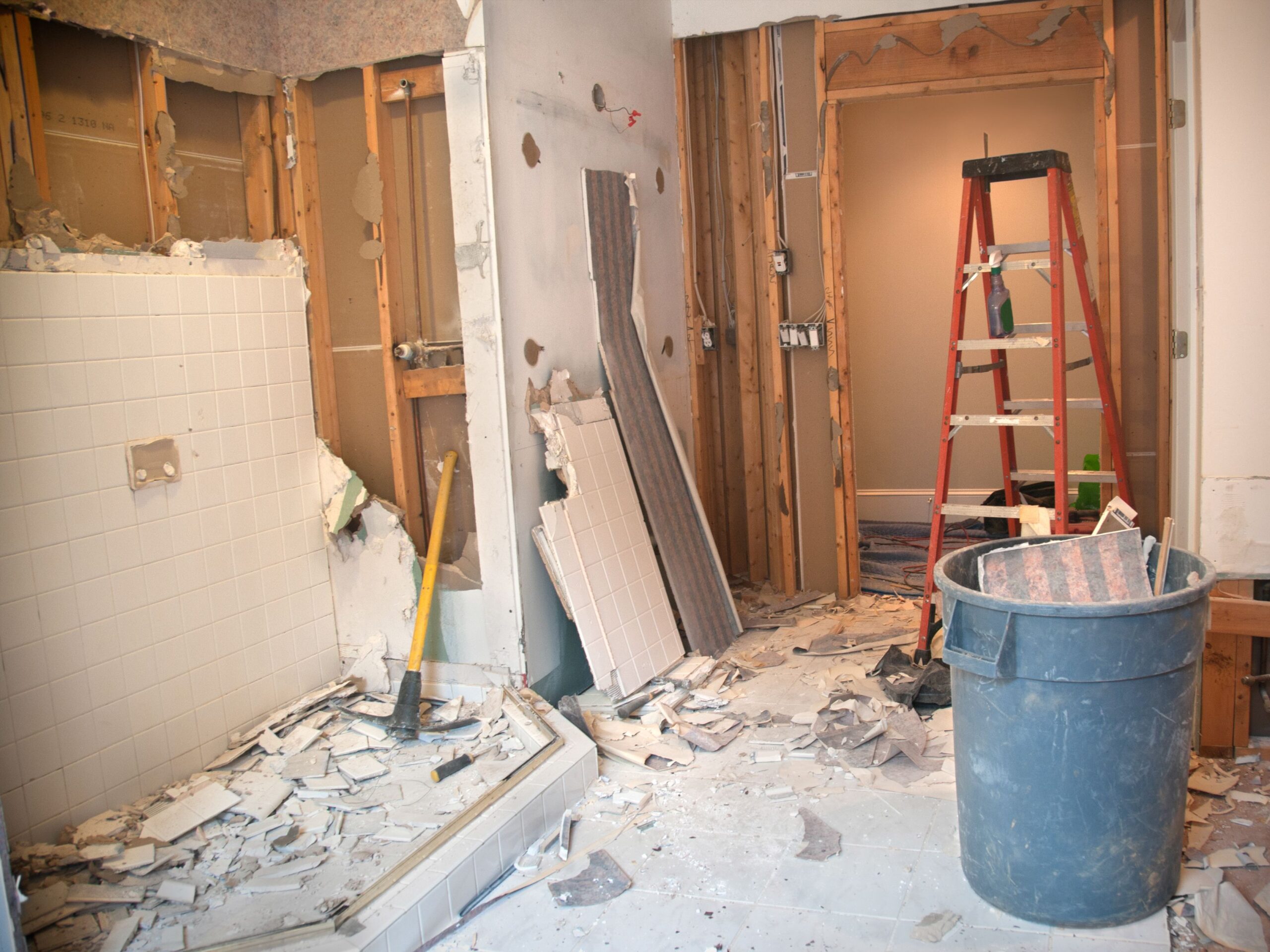 Master Bathroom Remodeling: Demolition Phase. The Master Bathroom is being demolished to the stud walls / subfloor level. Tiles are being taken down and wallpapers are being removed.