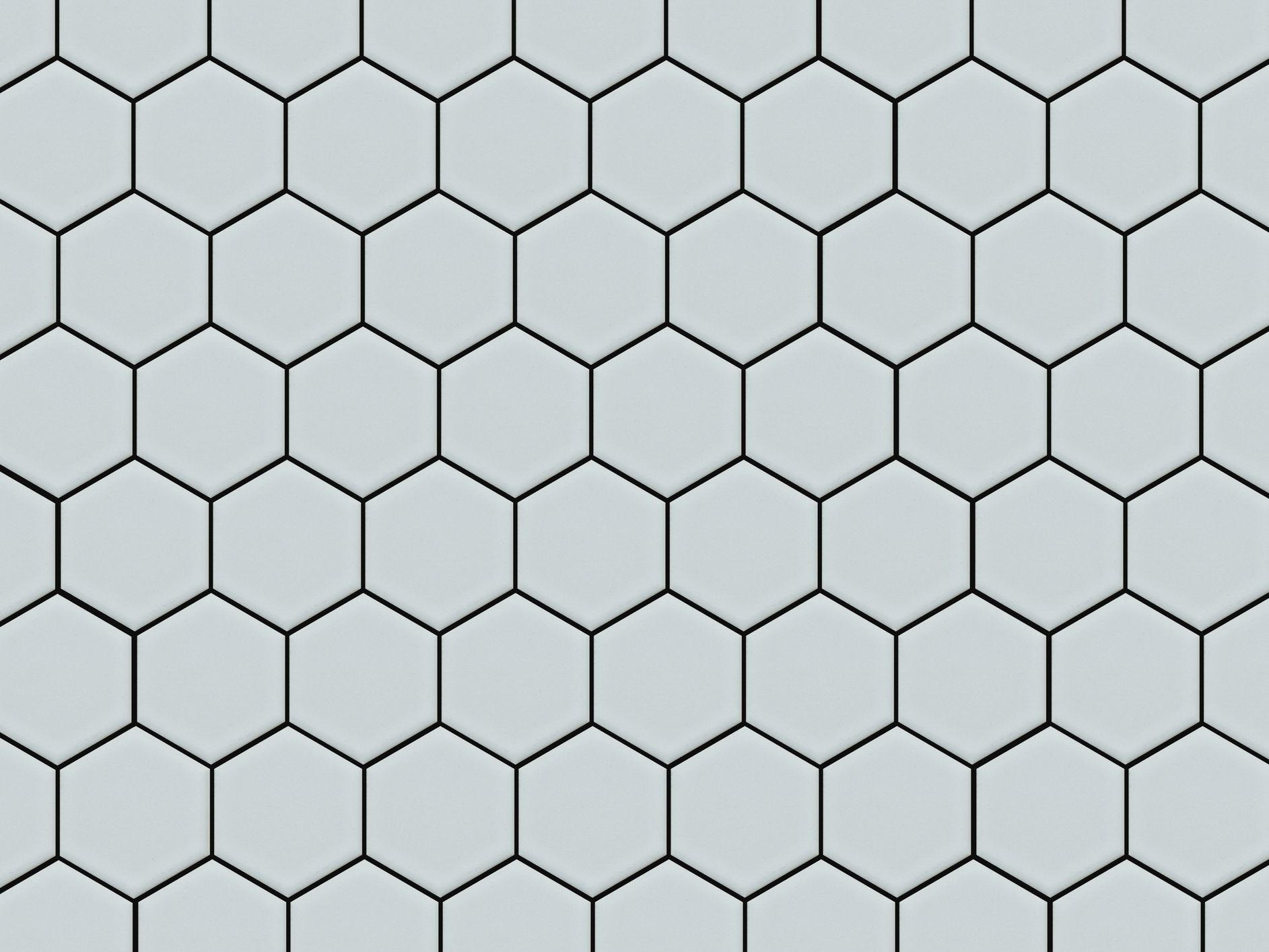 Honeycomb shaped hexagonal ceramic tile background in light blue or offwhite.
