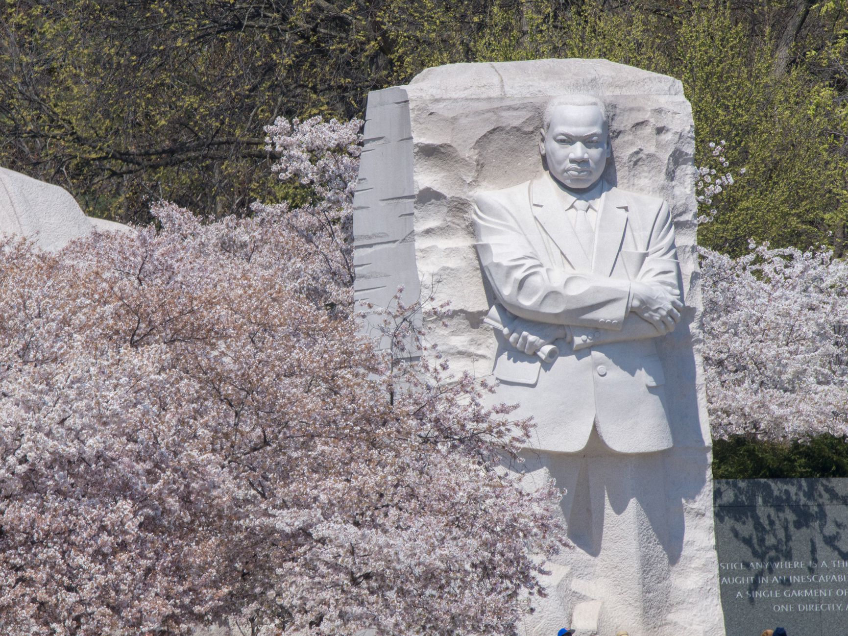 Visitors seem dwarfed by the towering sculpture of Martin Luther King, Jr.at the Tidal Basin in Washingon DC.