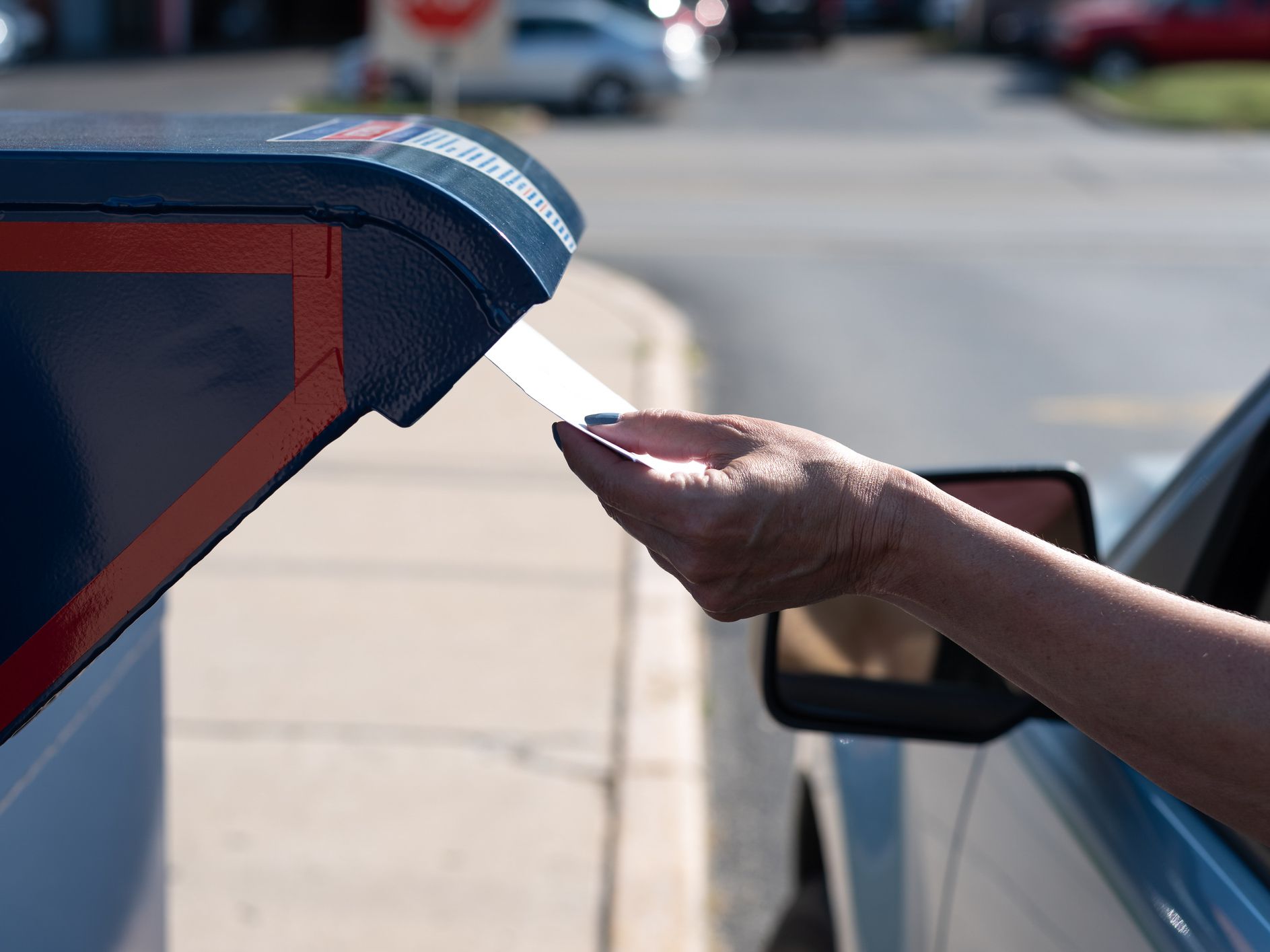 Palatine, IL/USA - 08-27-2020: Safely mailing an application for ballot for 2020 election at a drive-up mailbox at the US Post Office