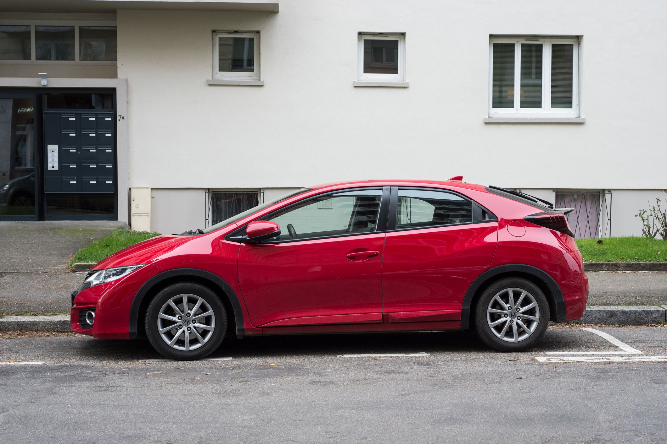 Mulhouse - France - 27 December 2020 - Profile view of red Honda Civic parked in the street