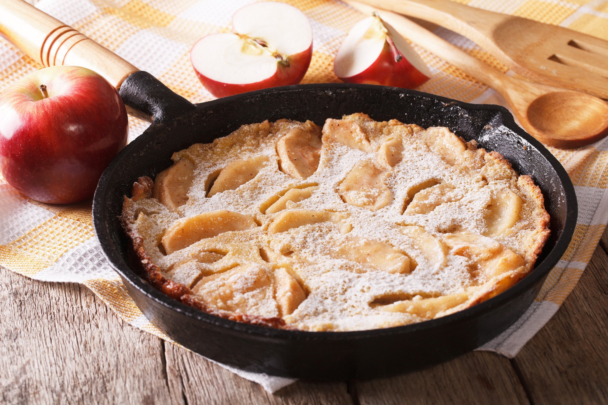 German apple pancake in skillet on table