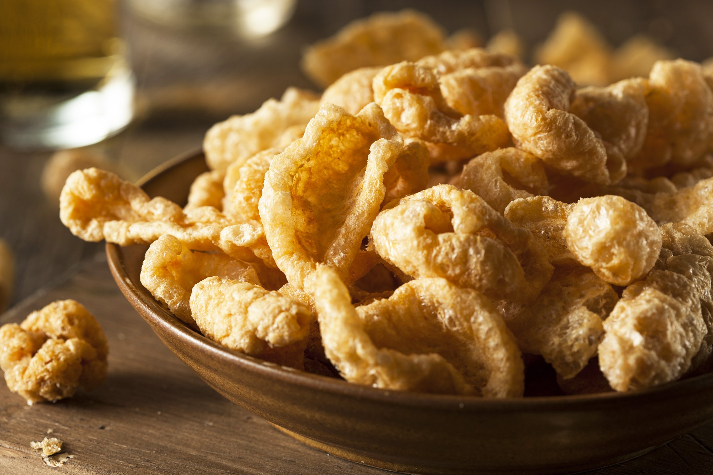 homemade pork rinds in bowl on table