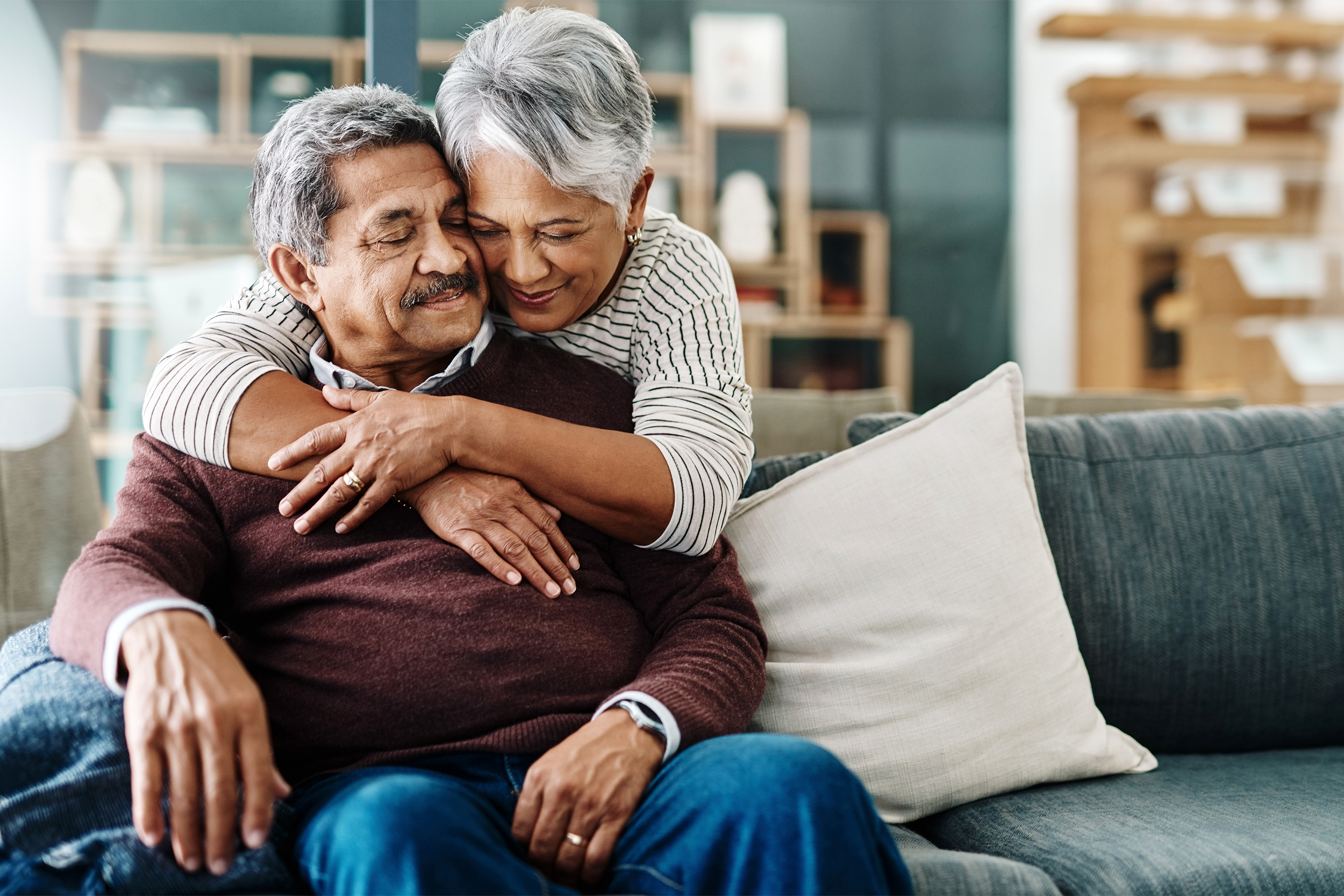 Senior couple hugging on couch