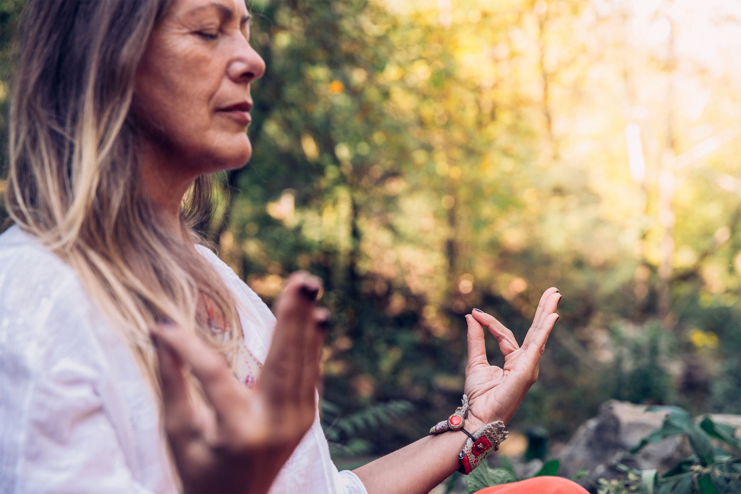 woman meditating in forest