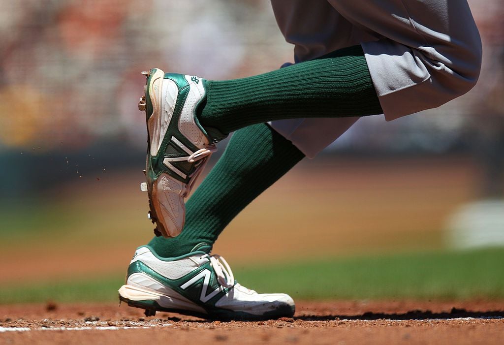 Close up detail of white and green New Balance cleats worn by Josh Reddick #16 of the Oakland Athletics during the game against the San Francisco Giants at AT&T Park on Saturday, May 19, 2012
