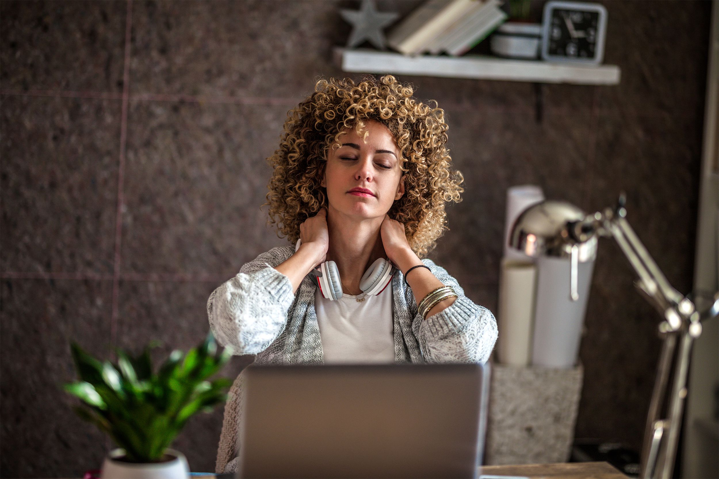 woman breathing deeply at her desk