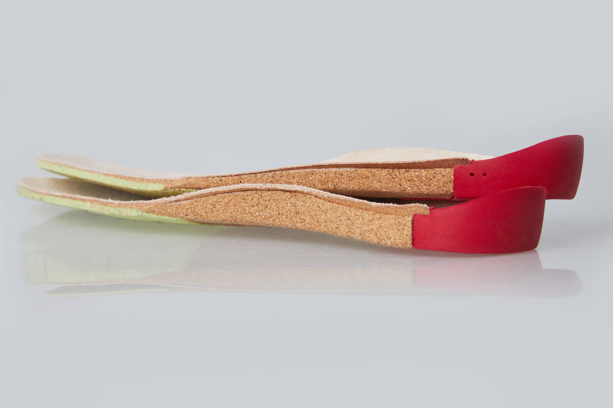 Orthotics on a white background. Insert in shoes to support the foot. Natural leather medical insole