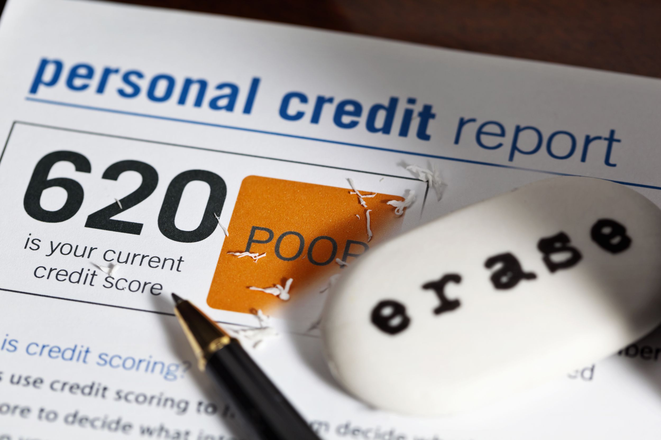 paper with 620 credit score, eraser, pen