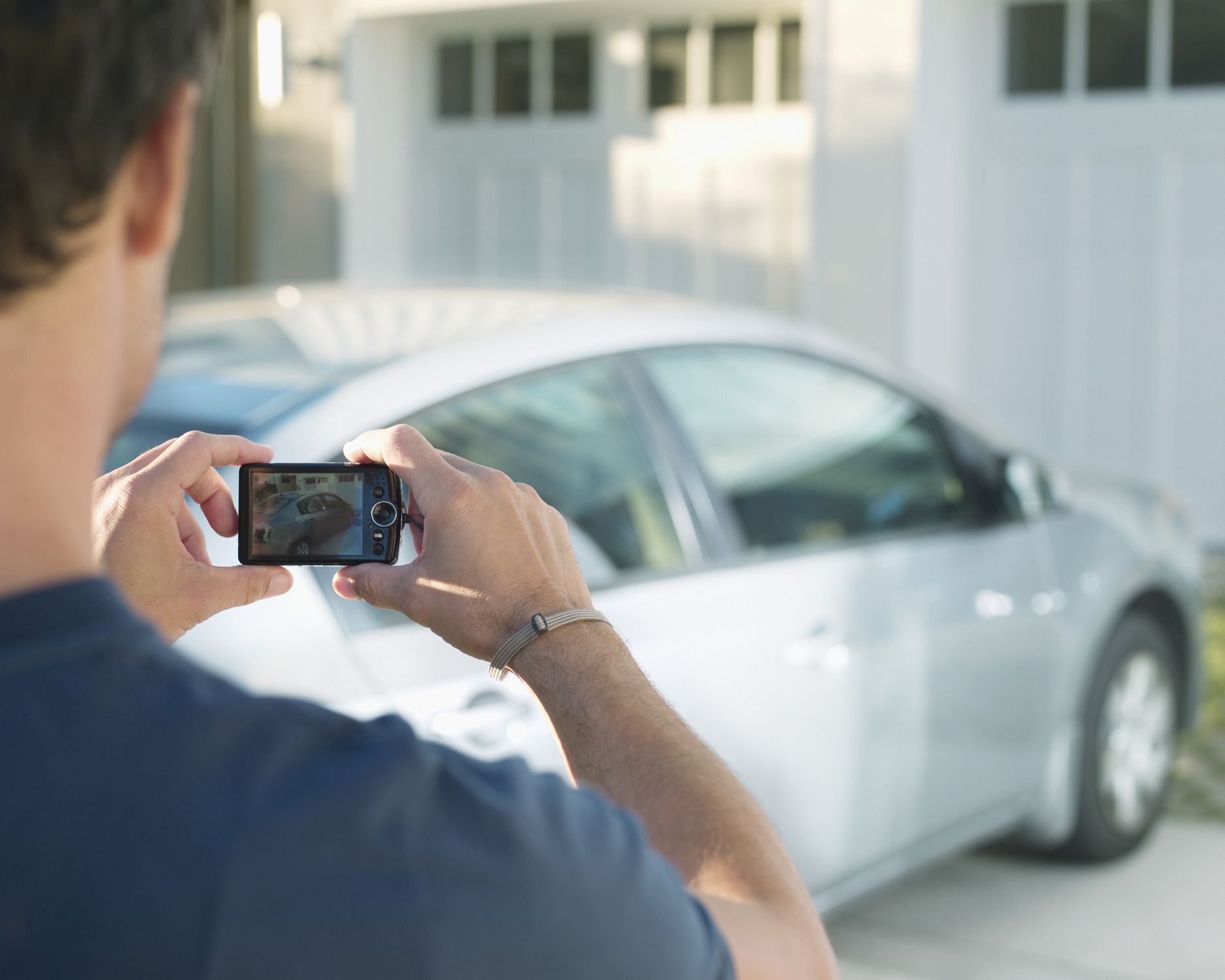 Man photographing car
