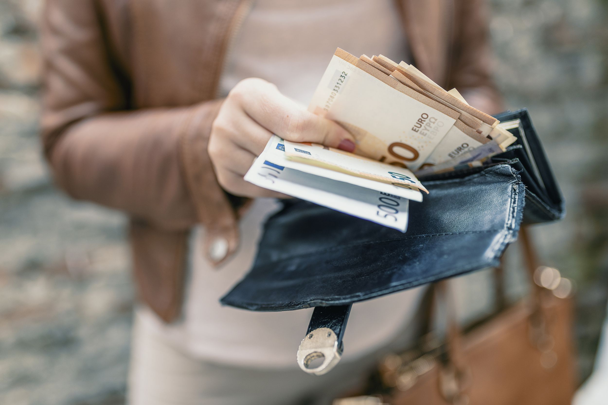 woman holding in hands wallet with euro money